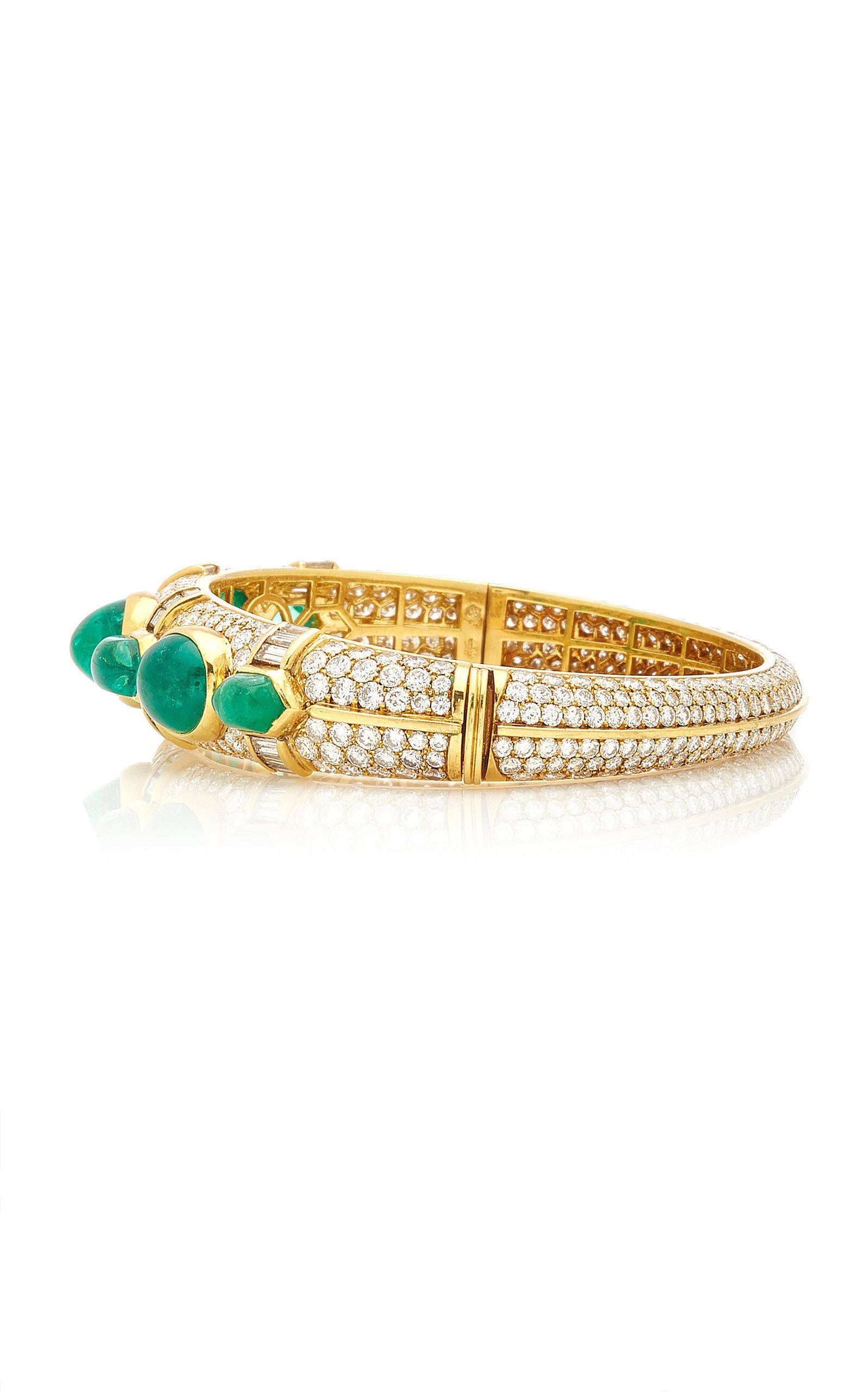 A beautiful bangle bracelet manufactured by Bulgari, presenting approximately 25 carats of fine quality cabochon emeralds and 18 carats of brilliant and baguette cut diamonds, on a fine 18kt yellow gold mounting. Made in Italy, circa 1965