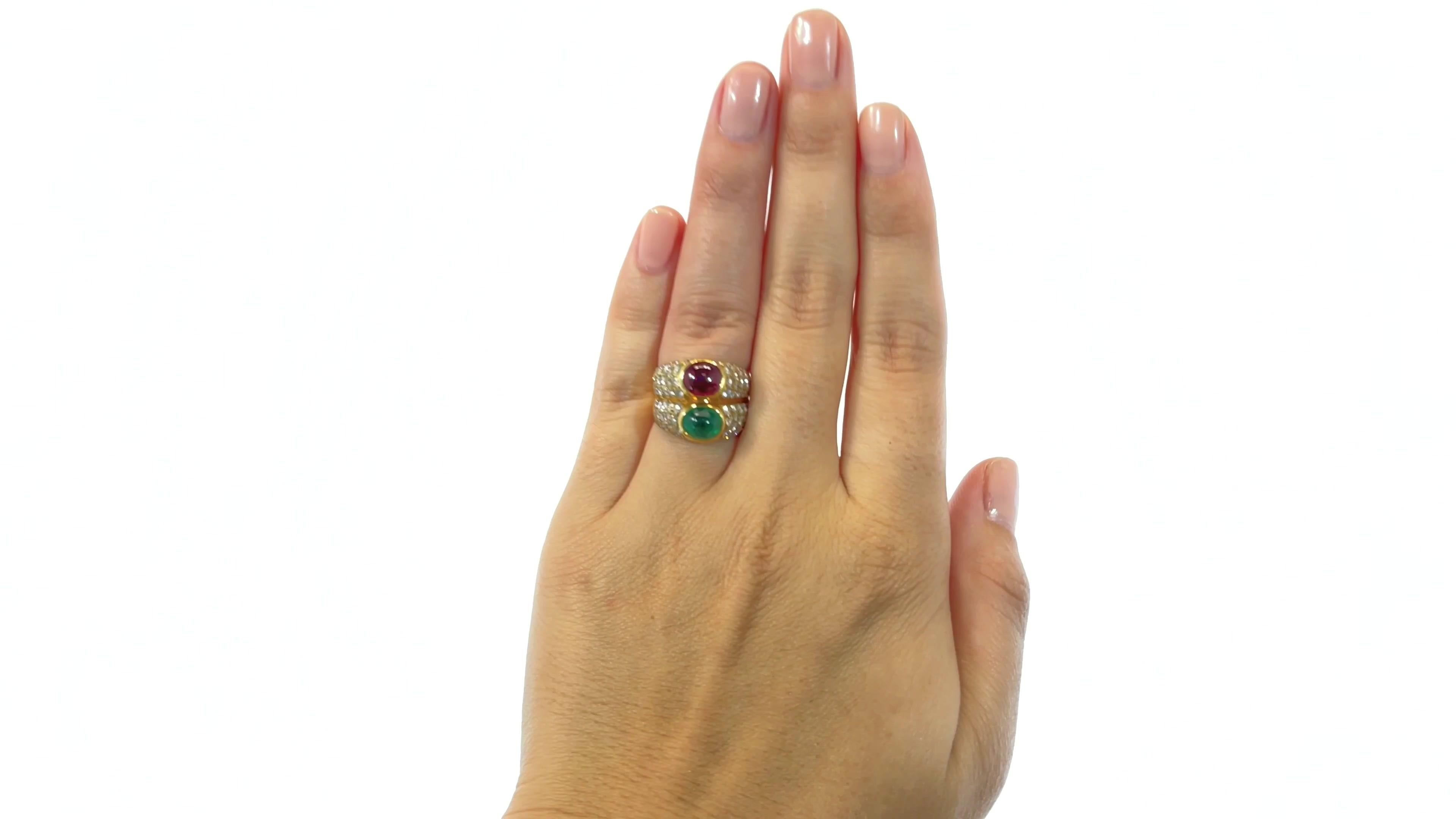 Bulgari Emerald Ruby Diamond 18 Karat Gold Ring. Featuring 1 cabochon cut ruby weighing 1.70 carats & 1 cabochon cut emerald weighing 1.31 carats. With 70 round brilliant cut diamonds approximately 2.20 carats D-E color, VVS clarity. Signed