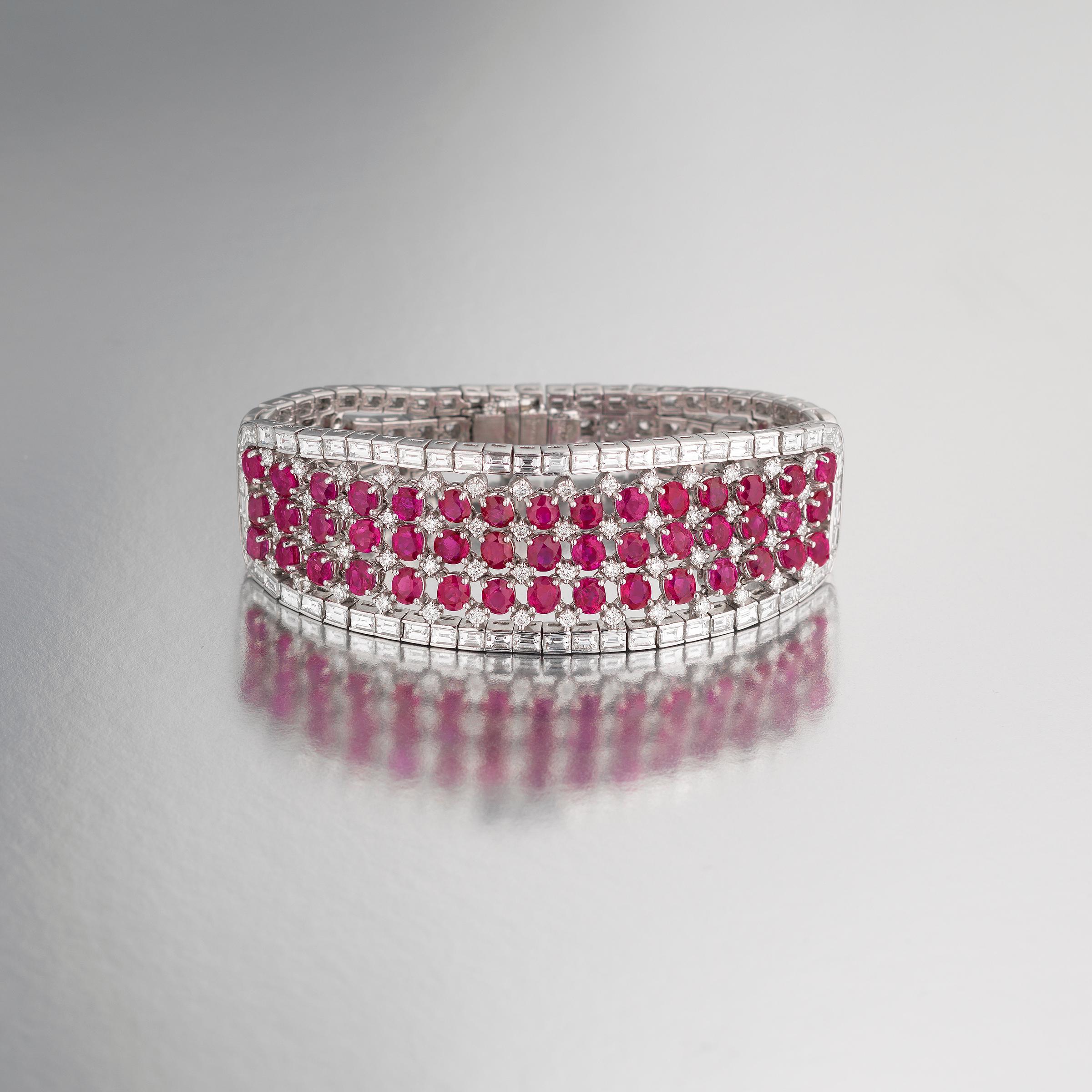 Dazzling Bulgari bracelet crafted in noble platinum and featuring approximately 10 carats of fine white diamonds and 20 carats of vivid red Burma rubies across its three sections. The bracelet radiates with red-carpet glamour of Bulgari high-jewelry