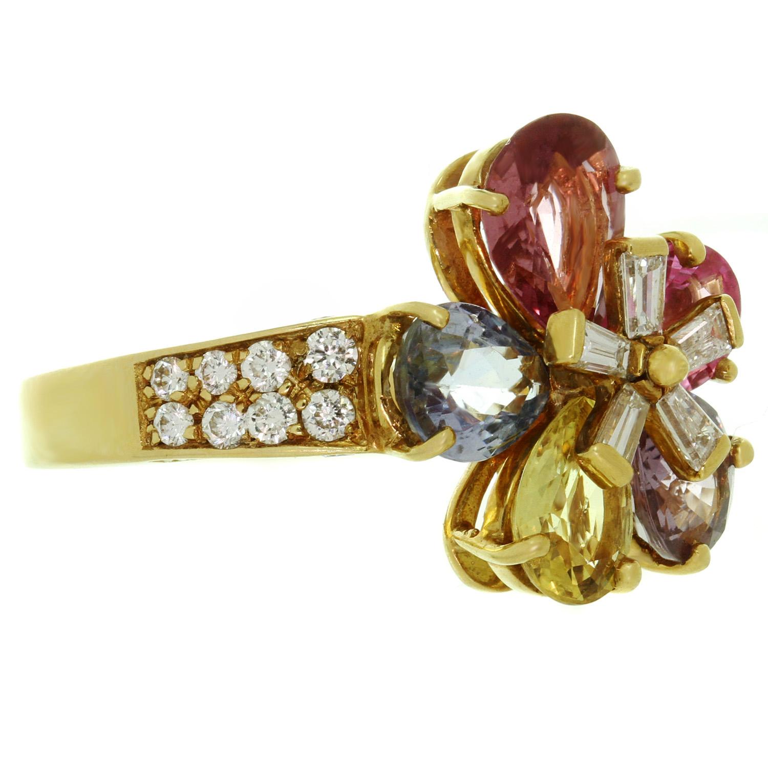 This exquisite ring from Bulgari's Flower collection is crafted in 18k yellow gold and features a diamond center and five petals of natural fancy pear-cut sapphires in beautiful shades of pink and blue weighing an estimated 4.50 carats. The shank is