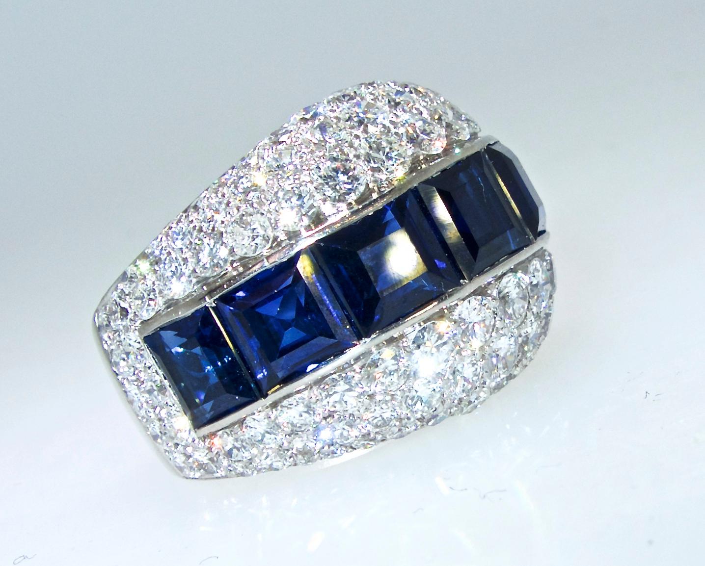 Platinum vintage Bulgari ring possessing fine natural bright blue sapphires.  Set girdle to girdle, the 7 well matched fine natural vivid blue sapphires weigh approximately 8.76 cts.  Accenting these center stones are fine white round brilliant cut