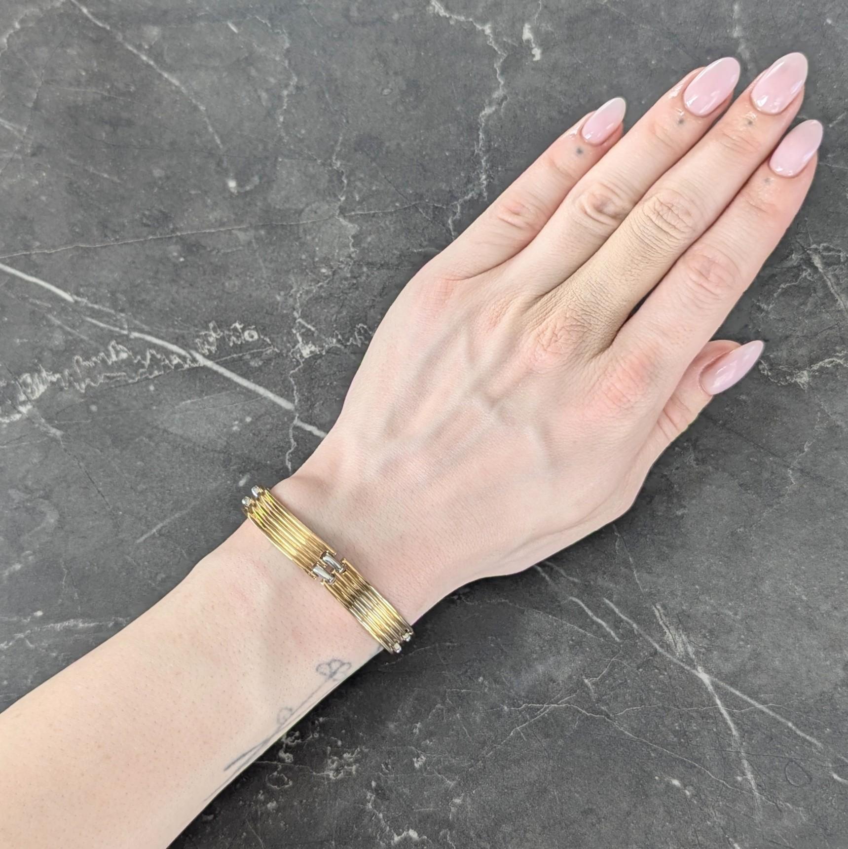 Comprised of curving yellow gold panel links with fluted detail
Alternating with platinum bar links
Links are slightly curved for comfort
Completed by concealed clasp closure
With hinged bar safety
Stamped with Italian assay marks for 18 karat gold