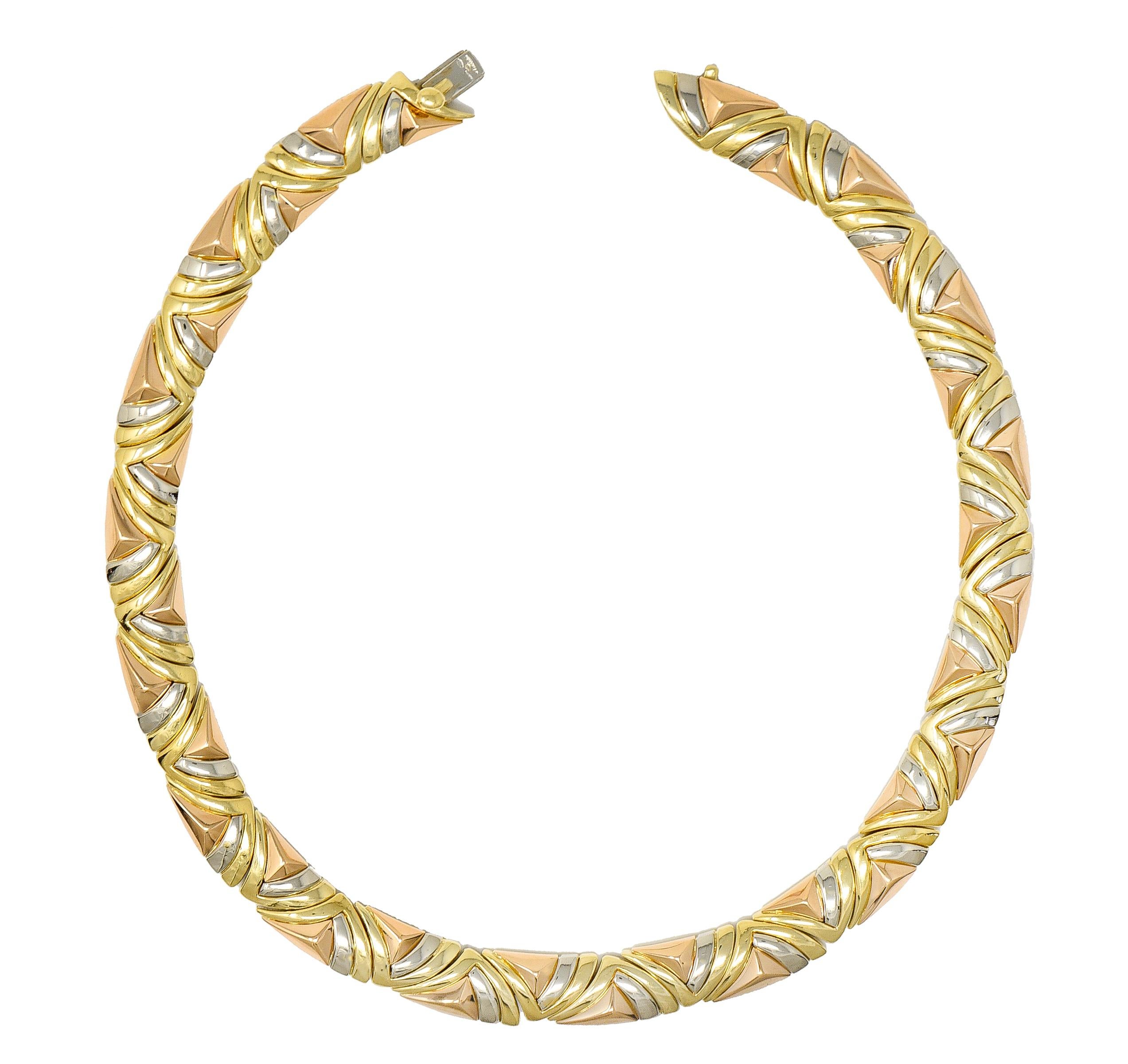 Designed as a collar necklace comprised of fitted forms in tri-gold
Rose gold forms are dimensional faceted pyramids
Yellow gold forms are sweeping chevrons
White gold forms are curved accents
With high polished finish
Completed by a concealed clasp