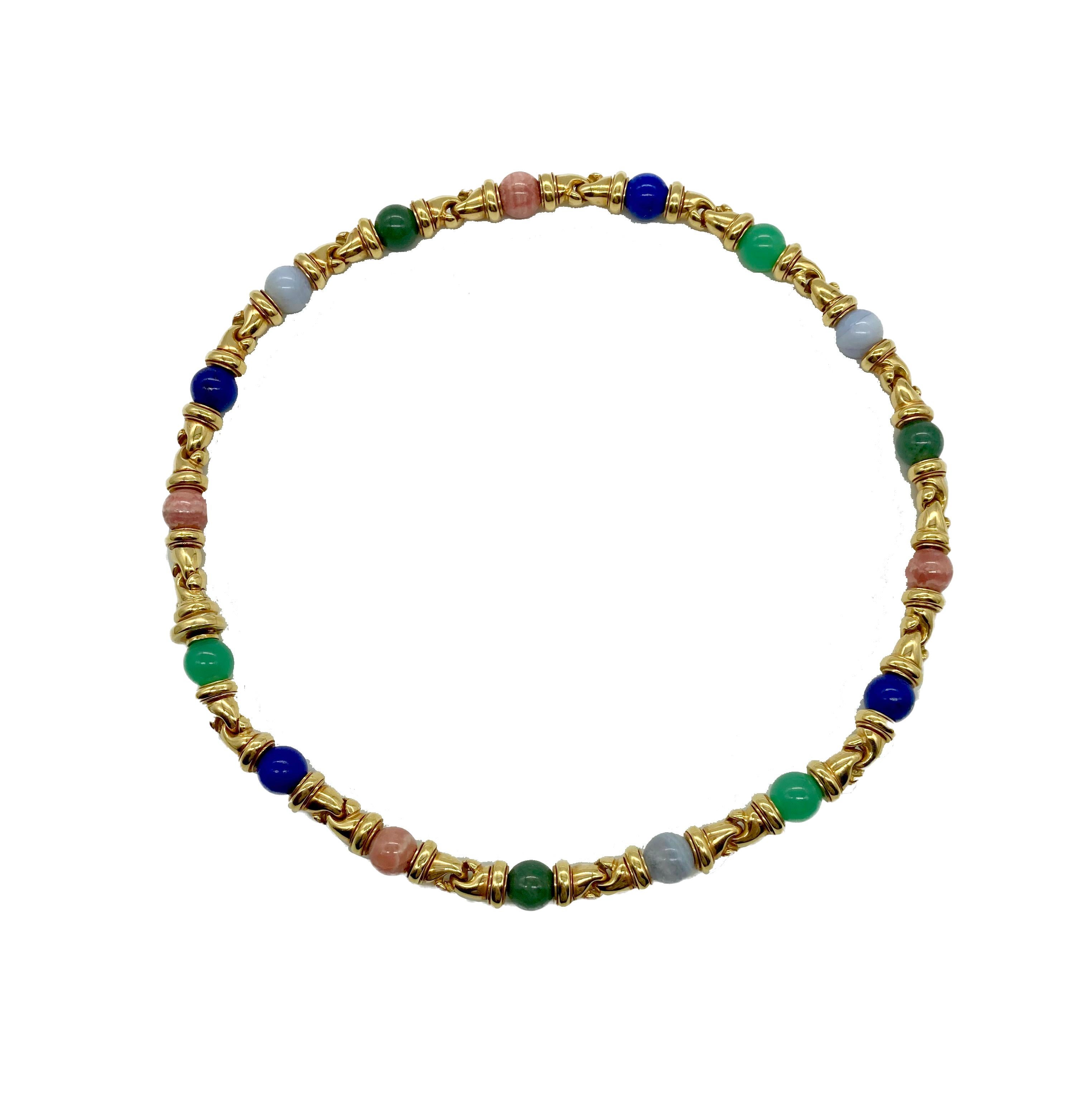 A colorful Bulgari Gancio 18 karat yellow gold necklace showcasing gemstone beads including lapis, rhodochrosite, chrysoprase, chalcedony, and malachite. Made in Italy, circa 1980s.