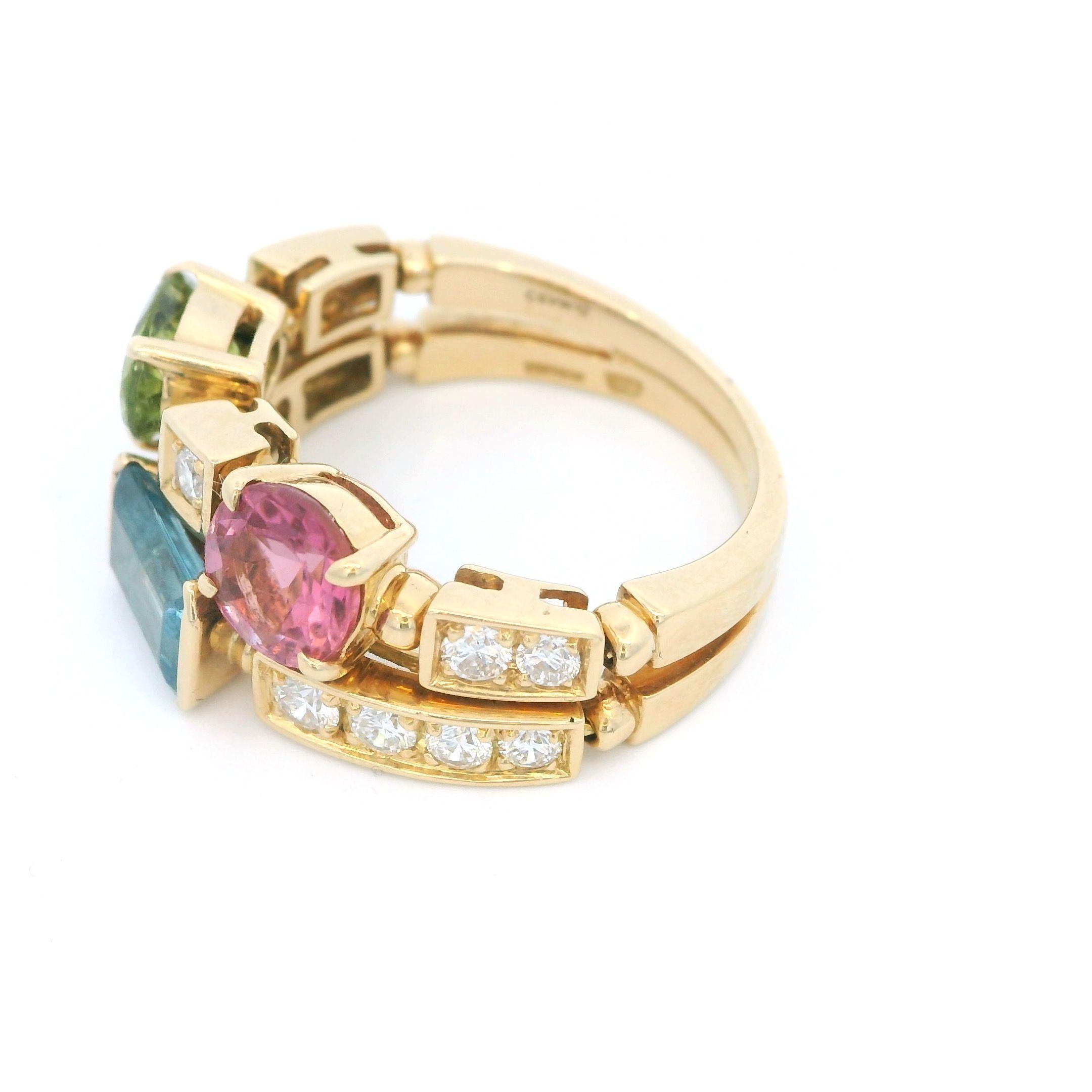 Mit einem Granat im Rundschliff, einem blauen Topas im Stufenschliff, einem Peridot im Ovalschliff und Diamanten im Brillantschliff besetzt, signiert Bulgari 
Dieser Artikel ist gebraucht und kann einige kleine Mängel aufweisen. Bitte informieren