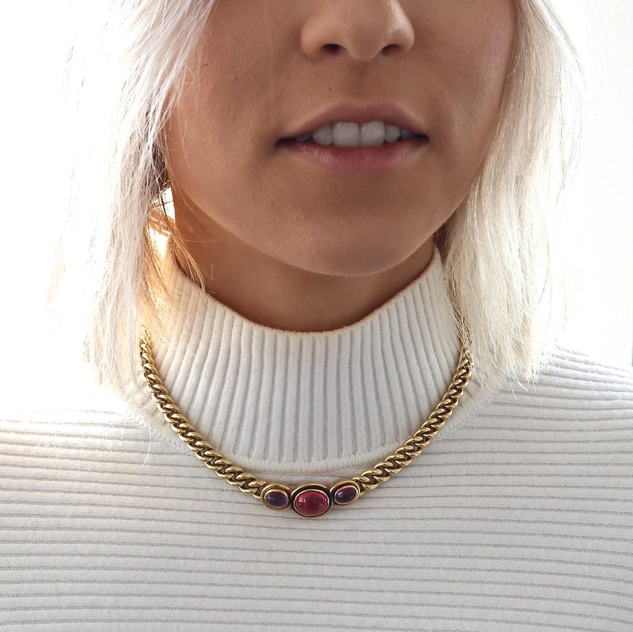 Heavy 18k gold link chain highlighted with perfect pink tourmaline and amethyst cabochons, in classic Bulgari style. Featuring two cabochon cut amethysts weighing approximately 1.32 carats each and one cabochon pink tourmaline approximately 5.06
