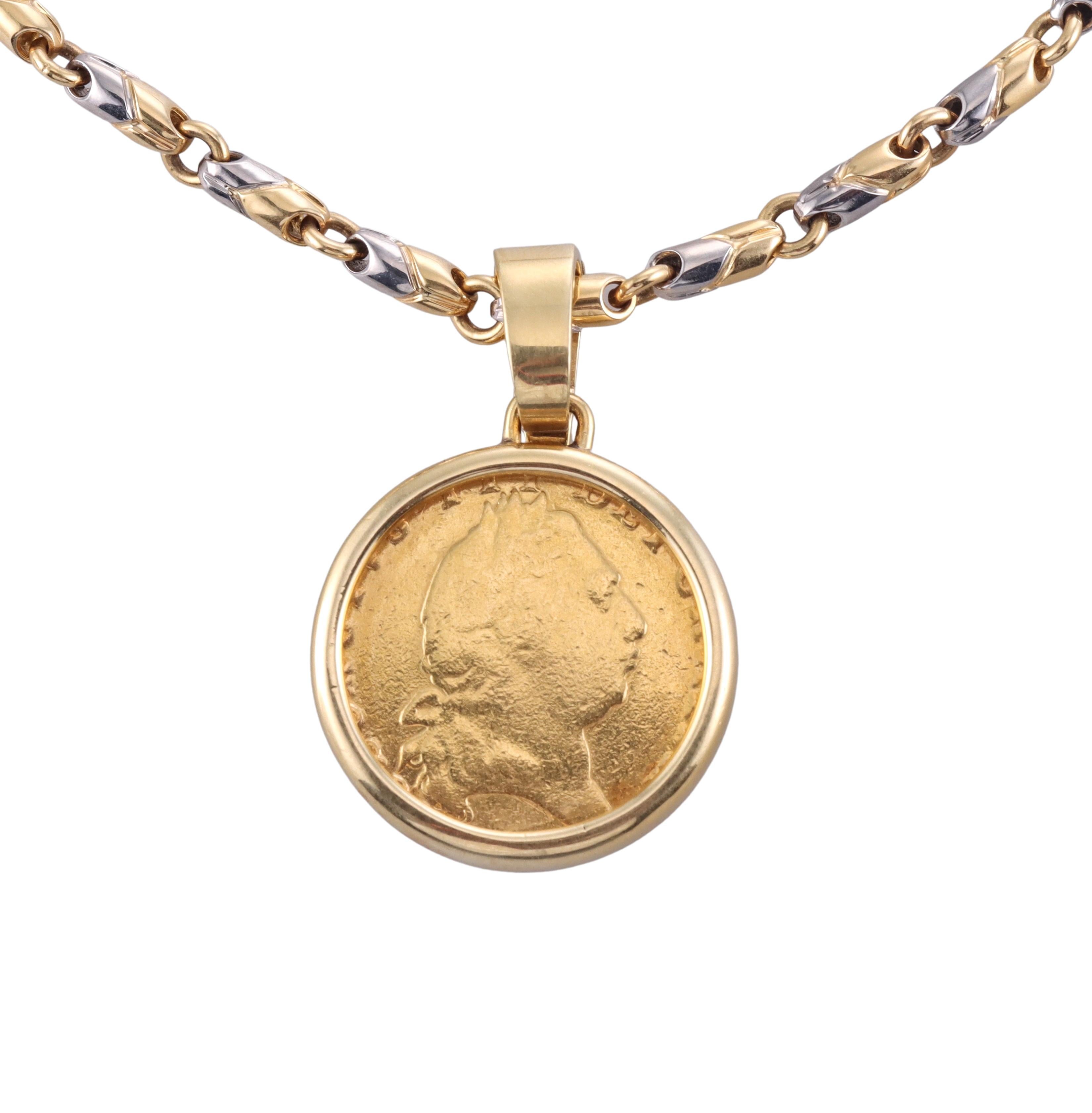 Iconic 18k gold and stainless steel chain necklace by Bvlgari, with a gold coin pendant. Necklace is 15
