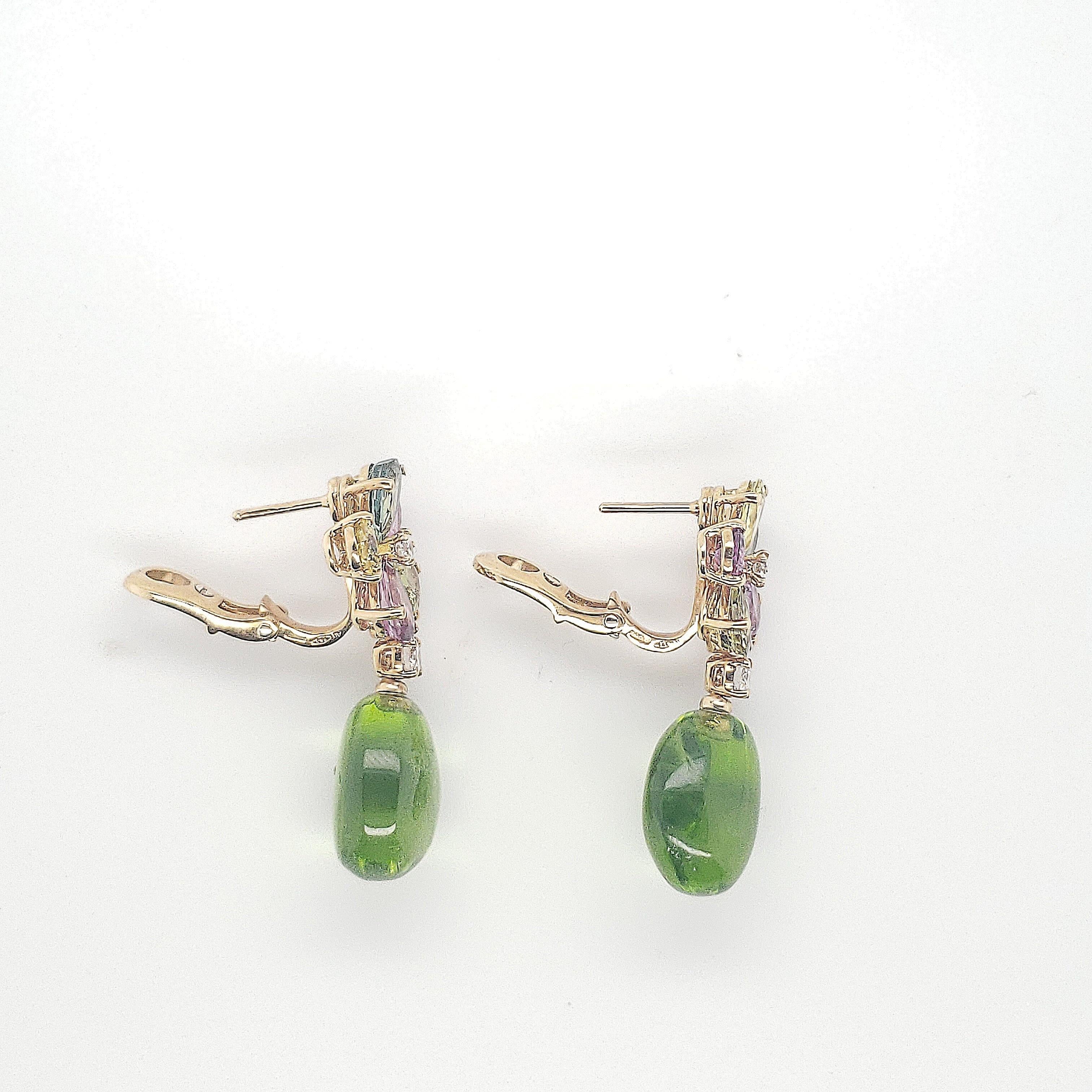 Authentic Bulgari mutli-colored sapphire and diamond flower earrings crafted in 18 karat yellow gold. Peridot drops measuring approx. 19 x 23mm each complete the earrings. The round brilliant cut diamonds (E-F color, VS clarity) weigh approx. 0.40