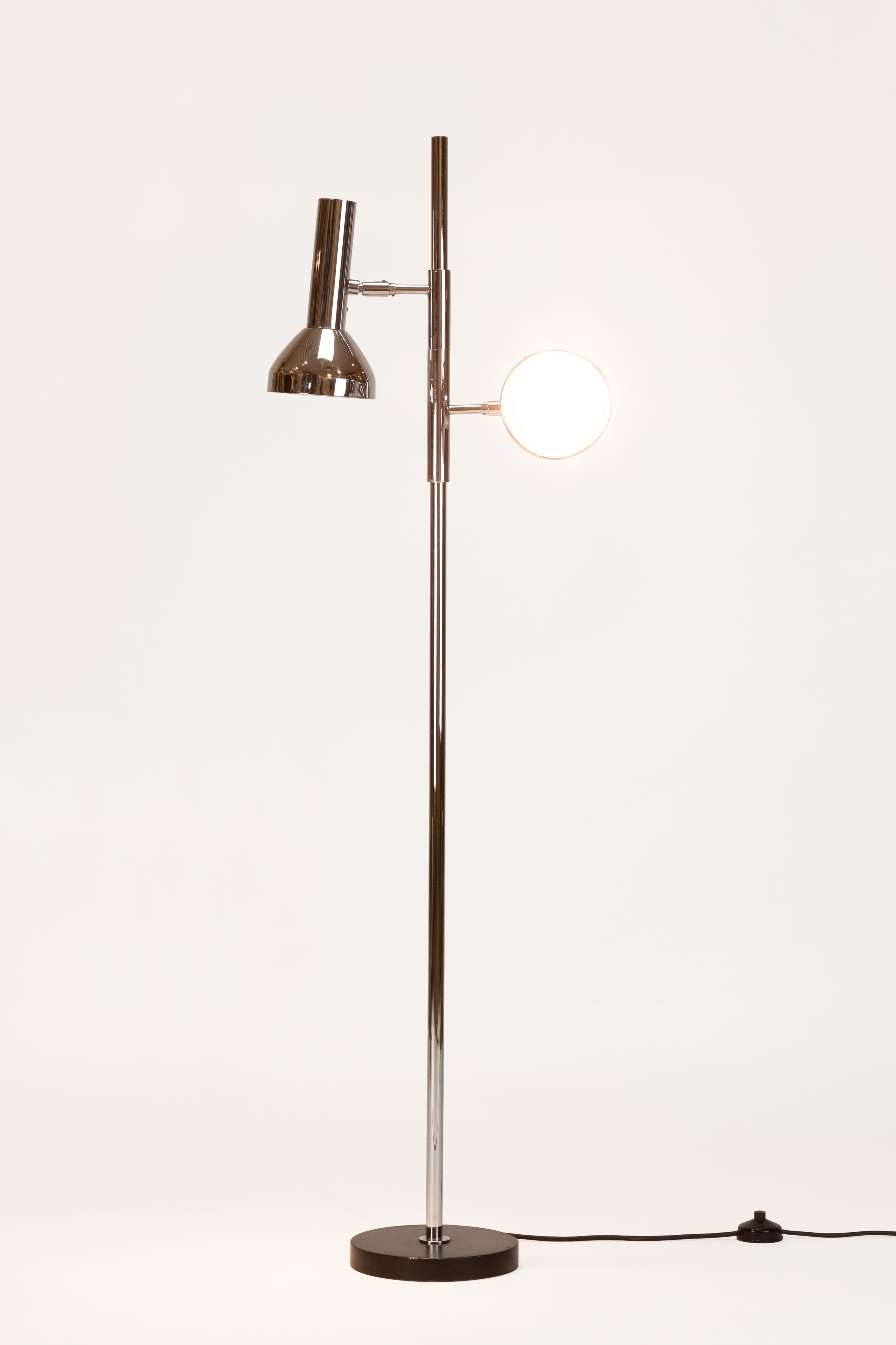 Spot floor lamp manufactured by Staff in the 1960s in Germany. Two adjustable spots attached with a cylindrical body to the pole.