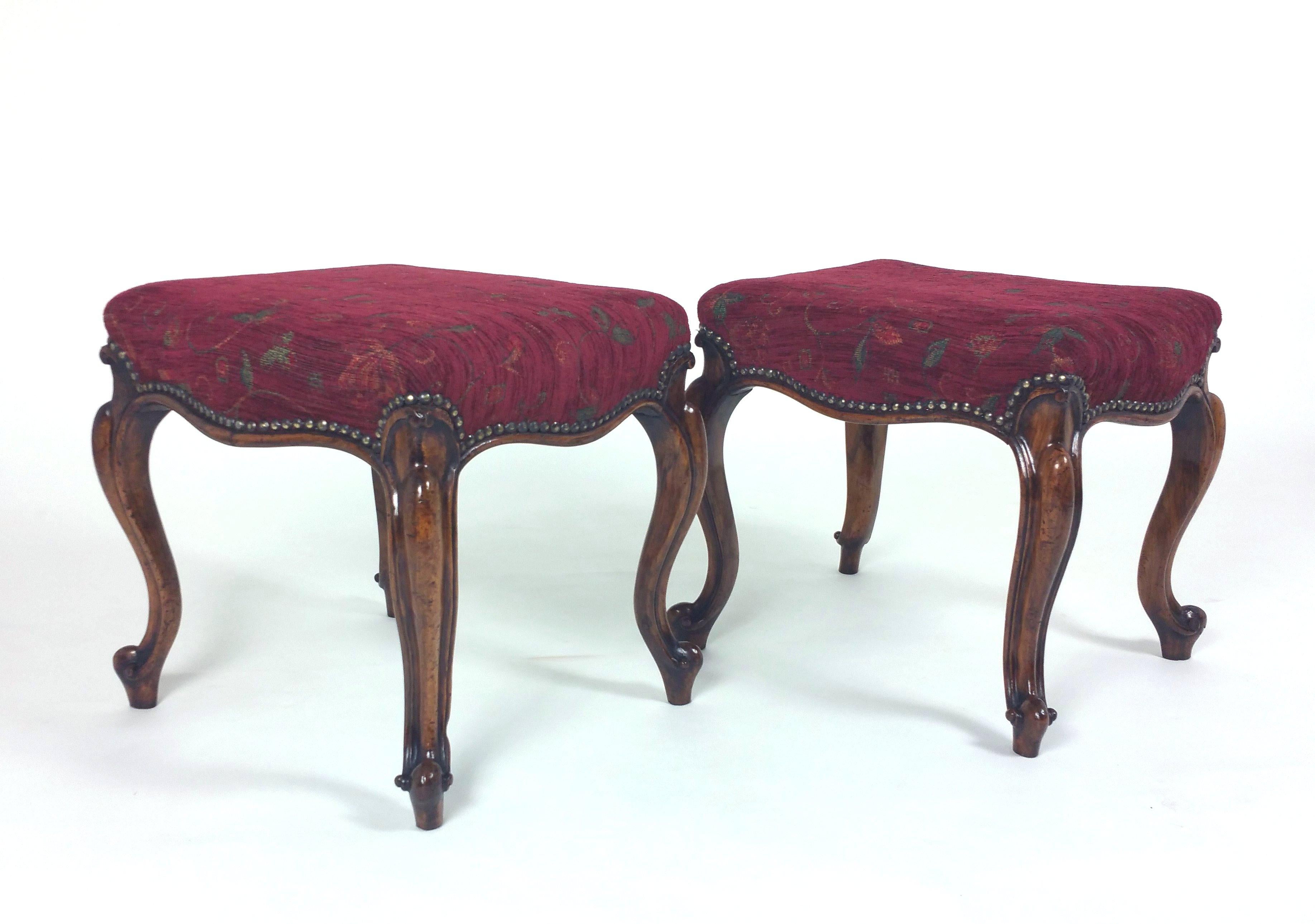 This beautiful and ornately carved pair of Victorian stools feature a rich deep red upholstered tapestry seats, supported on cabriole legs with scroll feet. Each stool measures 18 ½ in – 47 cm wide, 16 ½ in – 42 cm deep and 17 in – 43.2 cm high.