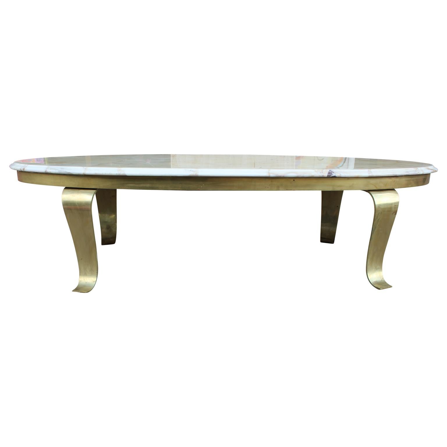 Gorgeous Hollywood Regency oval marble coffee table with brass legs, signed by Muller's Onyx / Muller of Mexico.