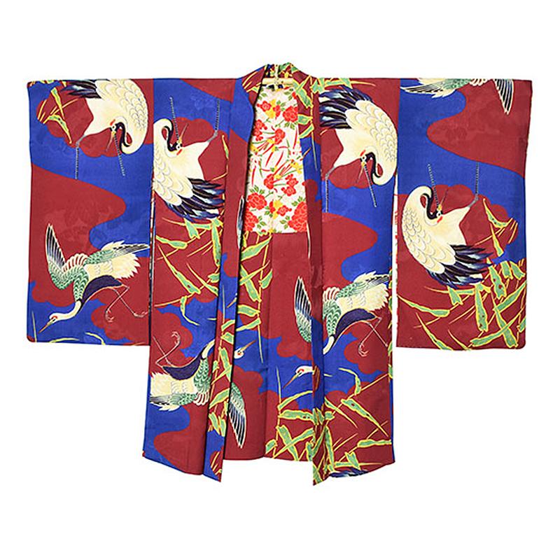 Vintage Japanese lined Haori made from silk jacquard with hand painted crane and bamboo motif on a red and blue background. It is in excellent condition for it's age and can be worn or displayed as a wall hanging to create a striking focal point in