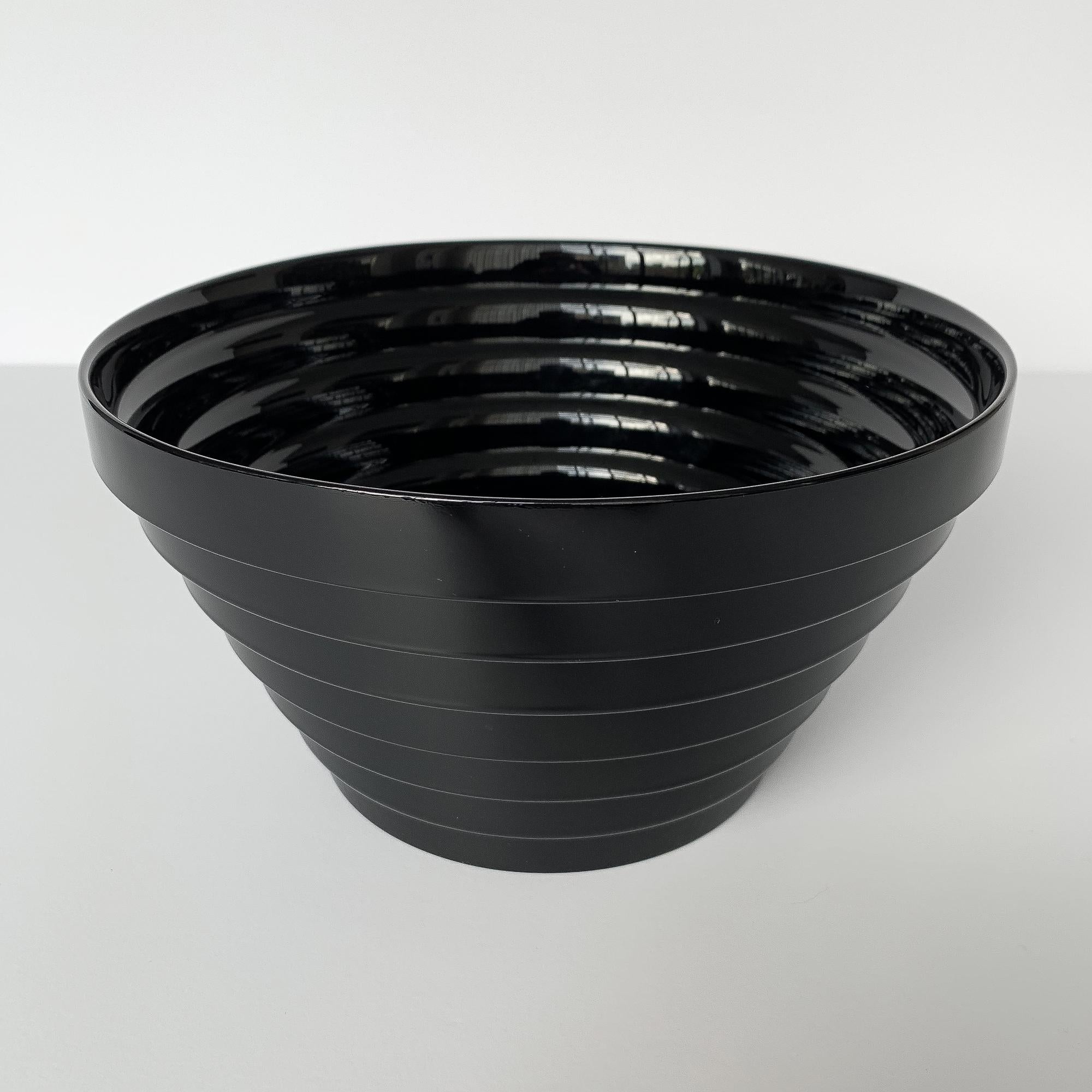Modernist Italian black glass bowl with unique stepped design on the interior and exterior. Reminiscent of designs by Sottsass and Sergio Asti. Original 
