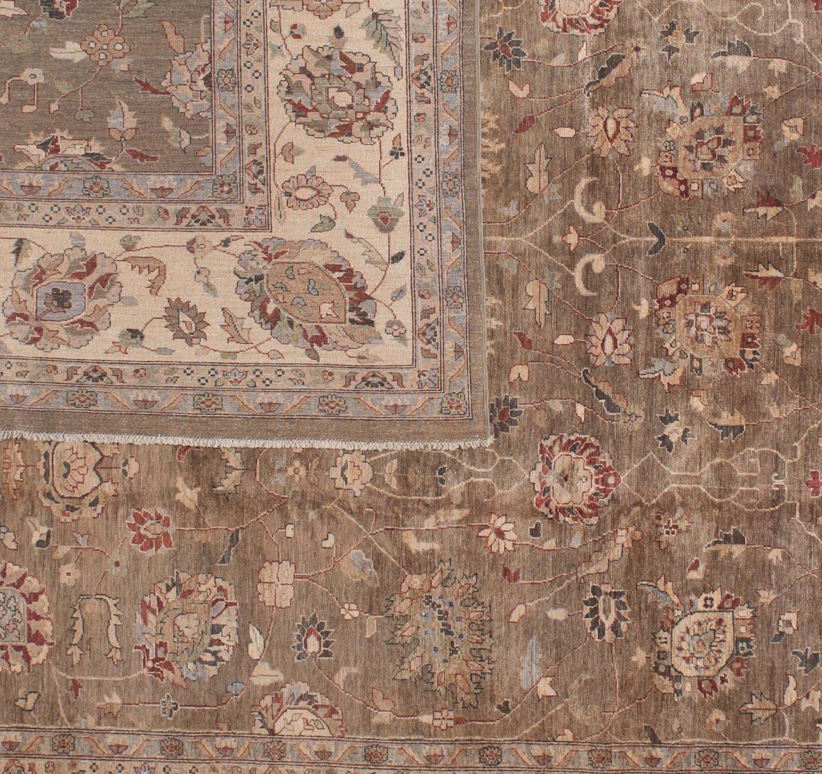 This traditional Pakistani floral motif design uses a bold and unusual palette that includes taupe, brown, teal, gray and red. The large brown center panel provides a rich background for a garden of jewels while the gold border adds additional