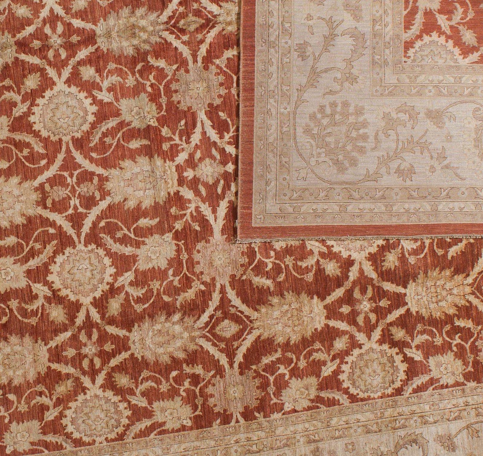 The bold red core of this traditional Pakistani design emphasizes the unusual oblong shape while the beige border adds the look of a fine brocade ribbon to define the edges. The net effect is an elegant and stylish rug that can serve as a