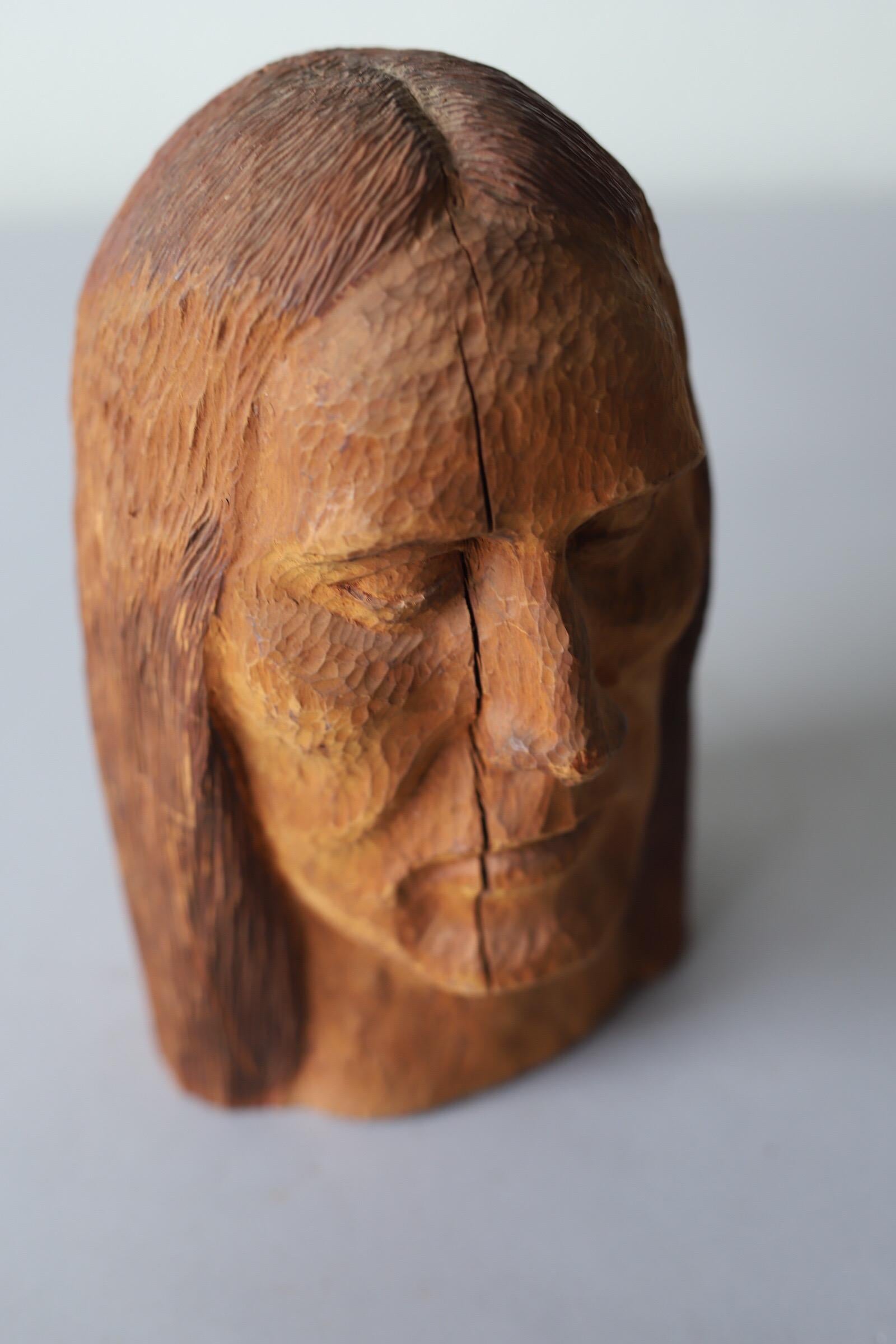 Amazing texture and detail on this hand carved wood head. A great accessory for any interior.
