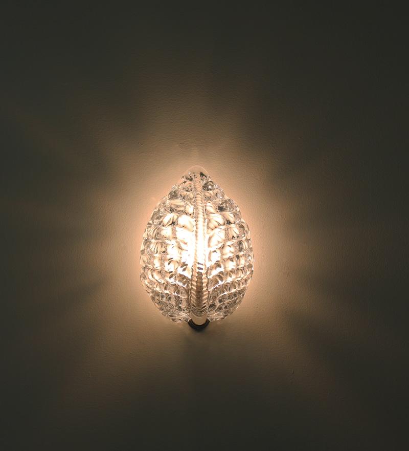 Beautiful wall lamps by Fritz Kurz for Orrefors, Sweden, 1940s.
The lamps consist of a crystal glass block on a chrome metal bottom. The glass shade is beautifully leaf-shaped and spreads a beautiful cozy light when lit. 

Condition: Excellent