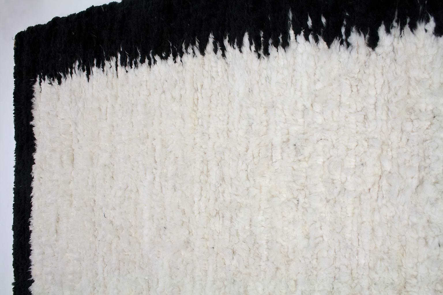 Very large and soft, black and white woven sheepskin hide, carpet or tapestry, 100% wool. The carpet is hand made yet, professionally woven and finished at the edges. The wool comes from a small ecological farm, of which the flock, in summer times,