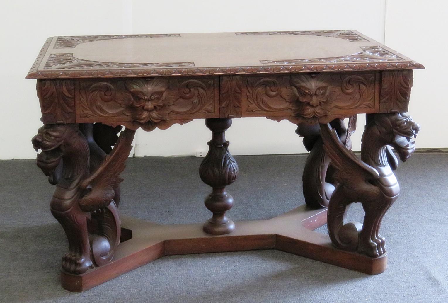 Oak Renaissance style winged griffin desk with 2 drawers.