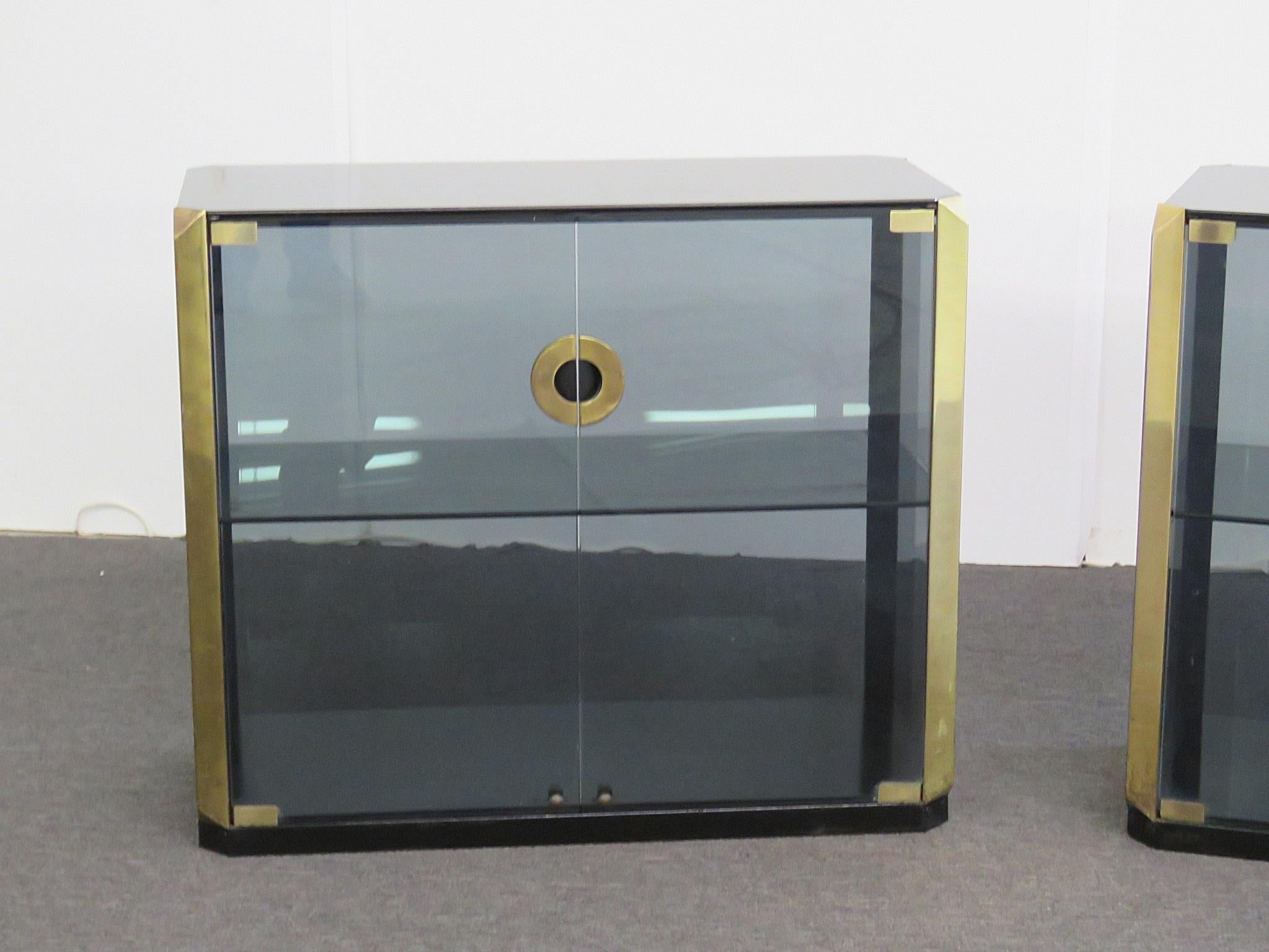 Pair of Mid-Century Modern 2-door Willy Rizzo with 1 shelf, smoked black glass and brass accents.