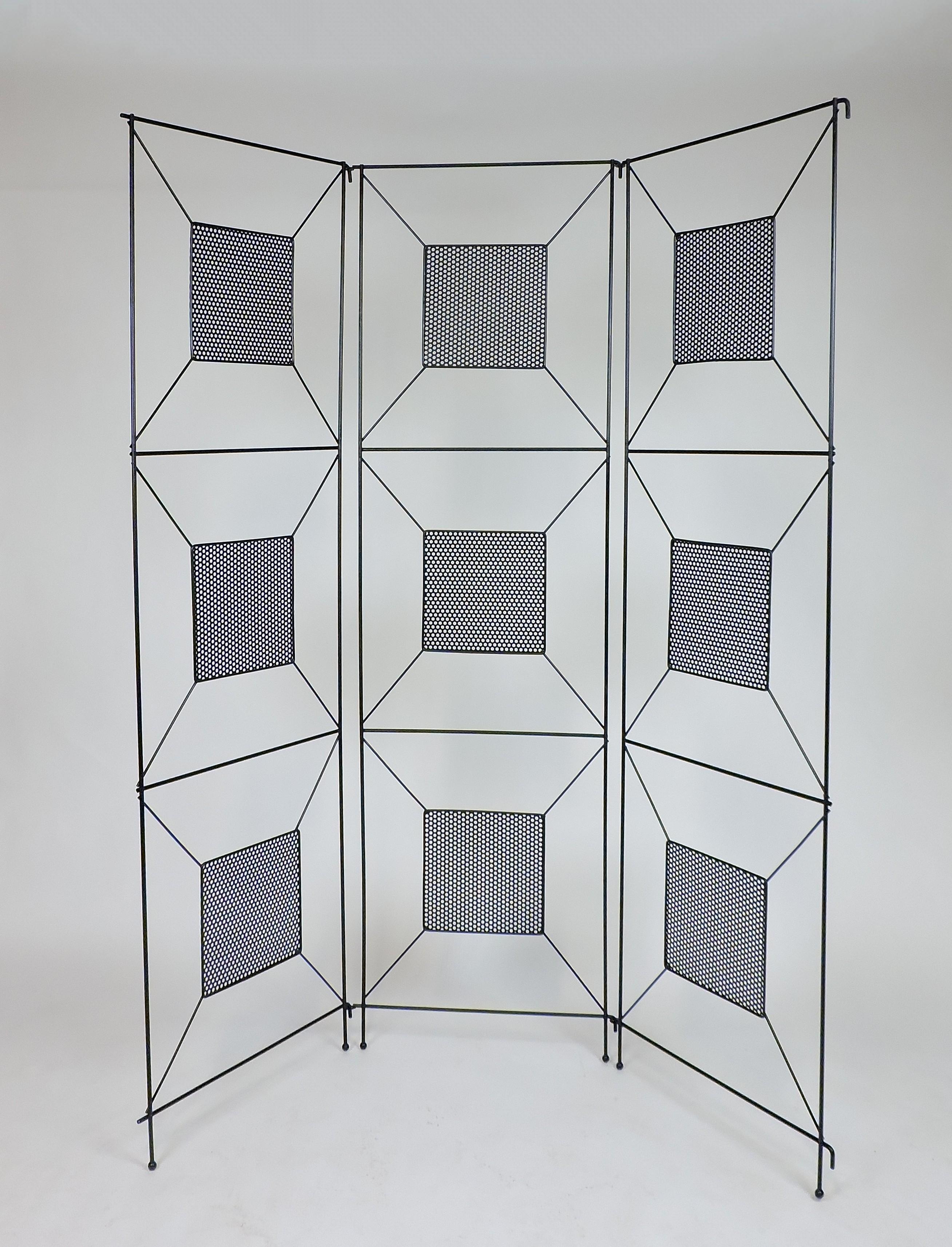 Mid-Century Modern three-piece room divider attributed to Frederick Weinberg. This screen has an iron frame with perforated center panels, and the original ball feet are all present. It has a great geometric modernist look. 
The panels come apart