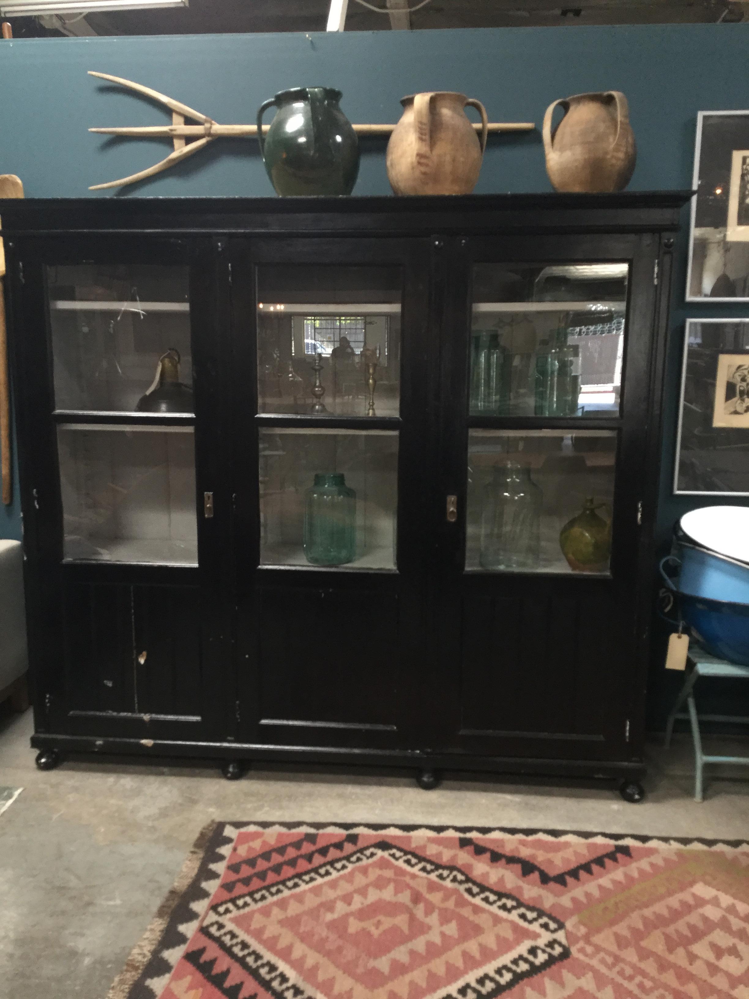 Beautiful black antique European hutch. Has three door-like cabinets, metal accents, and rounded feet. Comes with original key! Simple and classic. A perfect fit for almost every space.