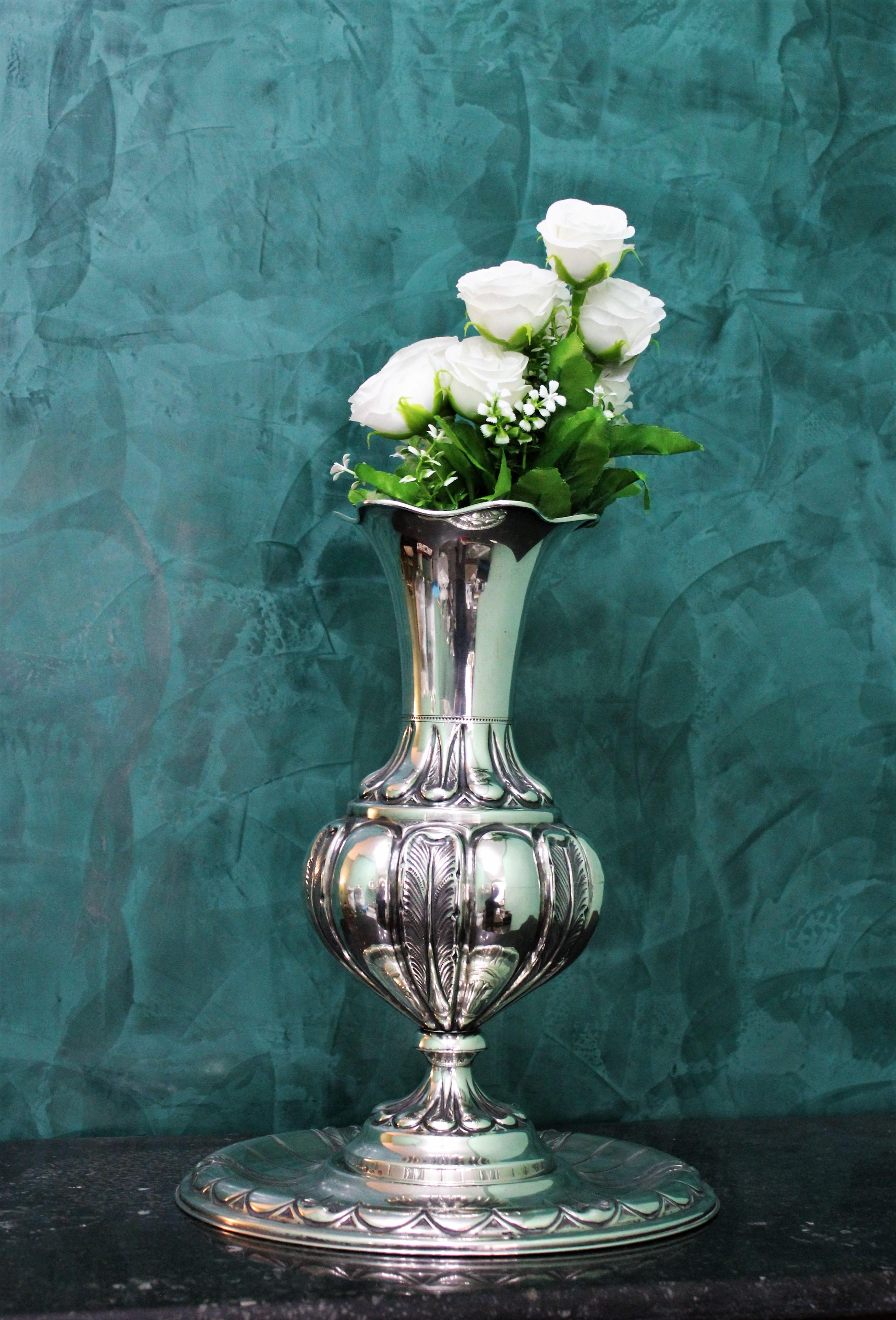 Beautiful silver flower vase with plate, embossed and engraved by hand around the end of 1940s in Milan, Italy.

Measures: Height 32 cm
Width 16.5 cm
Diameter of the plate 26.5 cm.