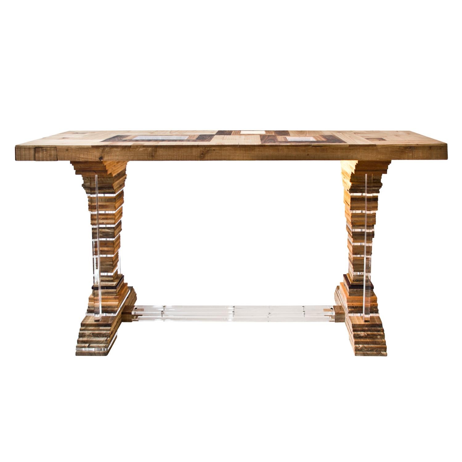 The small up]side[down console is made of handcrafted wood and plexiglass; the form of the two table legs remind a pyramidal trunk - typical of the 18th century - a chunky version of the Louis XVI style. As the title suggests, some elements can be