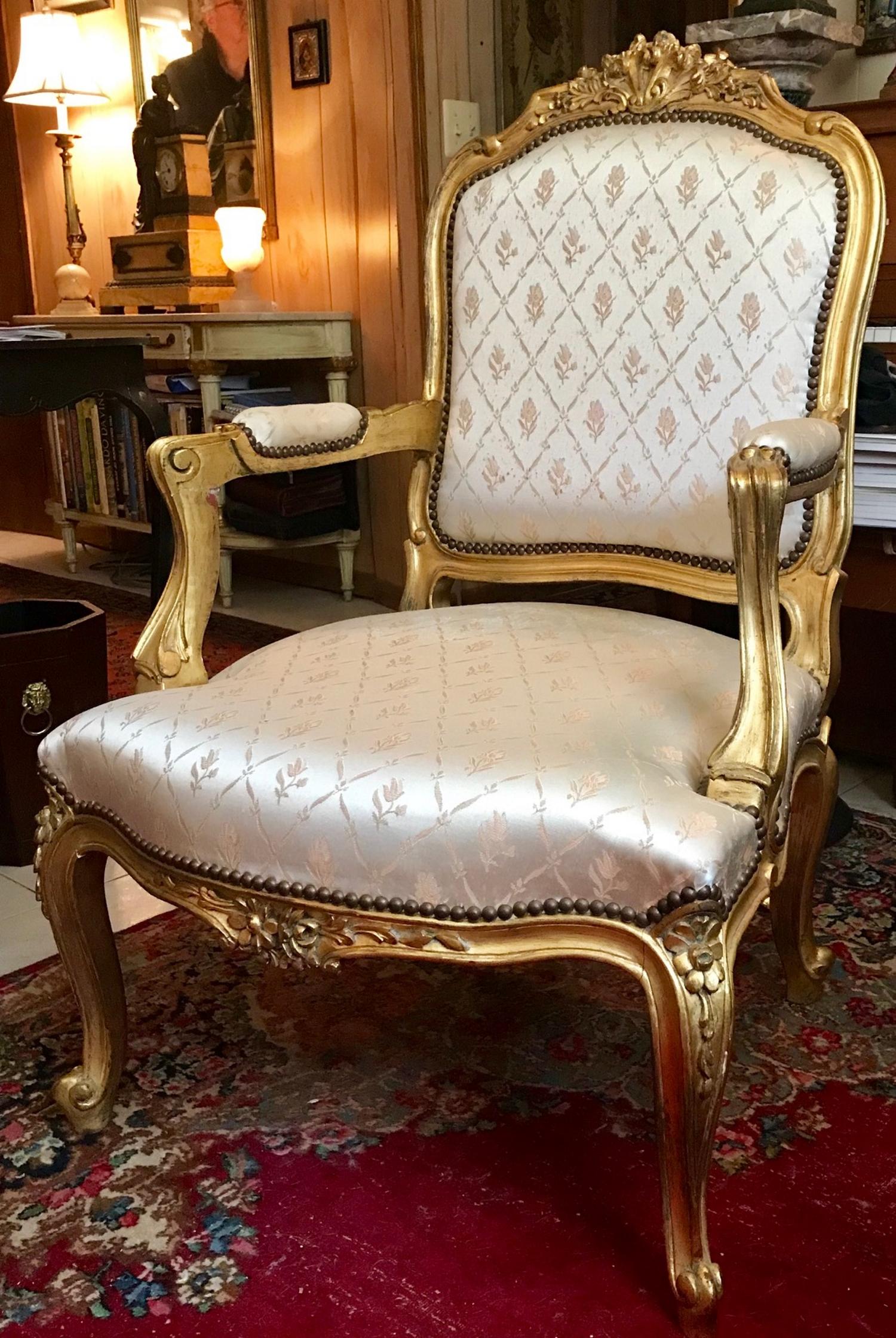 Louis XV Style Carved Giltwood Armchair Fauteuil

This elegant and regal armchair has a masterfully carved frame with acanthus and
shell scroll designed arms. The cabriole legs end in foliate scrolls. The cartouche shaped padded back, arms and seat