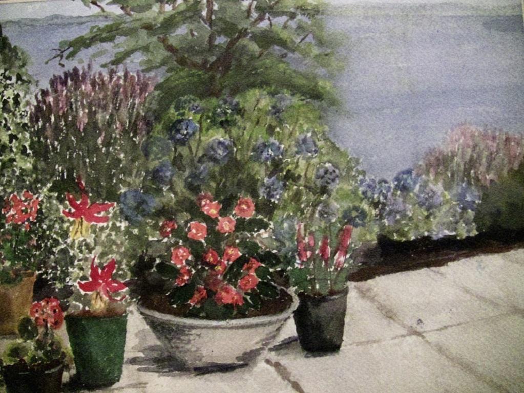 Beautiful original “still life” watercolor of Flower Patio Scene by Irish Watercolorist M. MacLoughlin.

Framed under glass…………….20th century, circa 1970.

Gorgeous colors with estuary in the background.

 