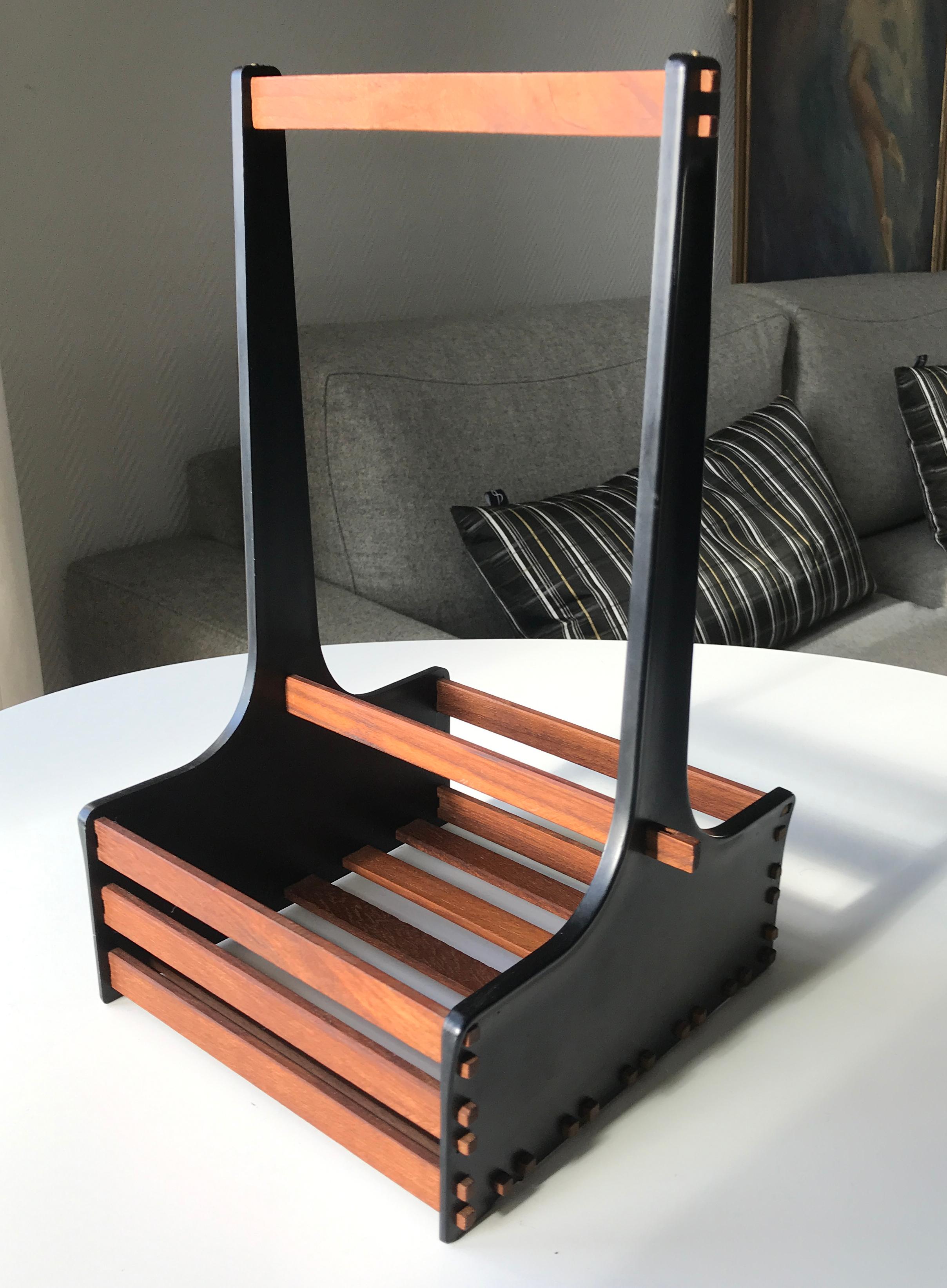 Mid-Century Niels Prahm design Copenhagen rare Danish teak bottle tray holder. Black acryl frame supporting massive teak stringers creating a great contrasts between the materials. The size makes it suitable for both beverage bottles as well as an