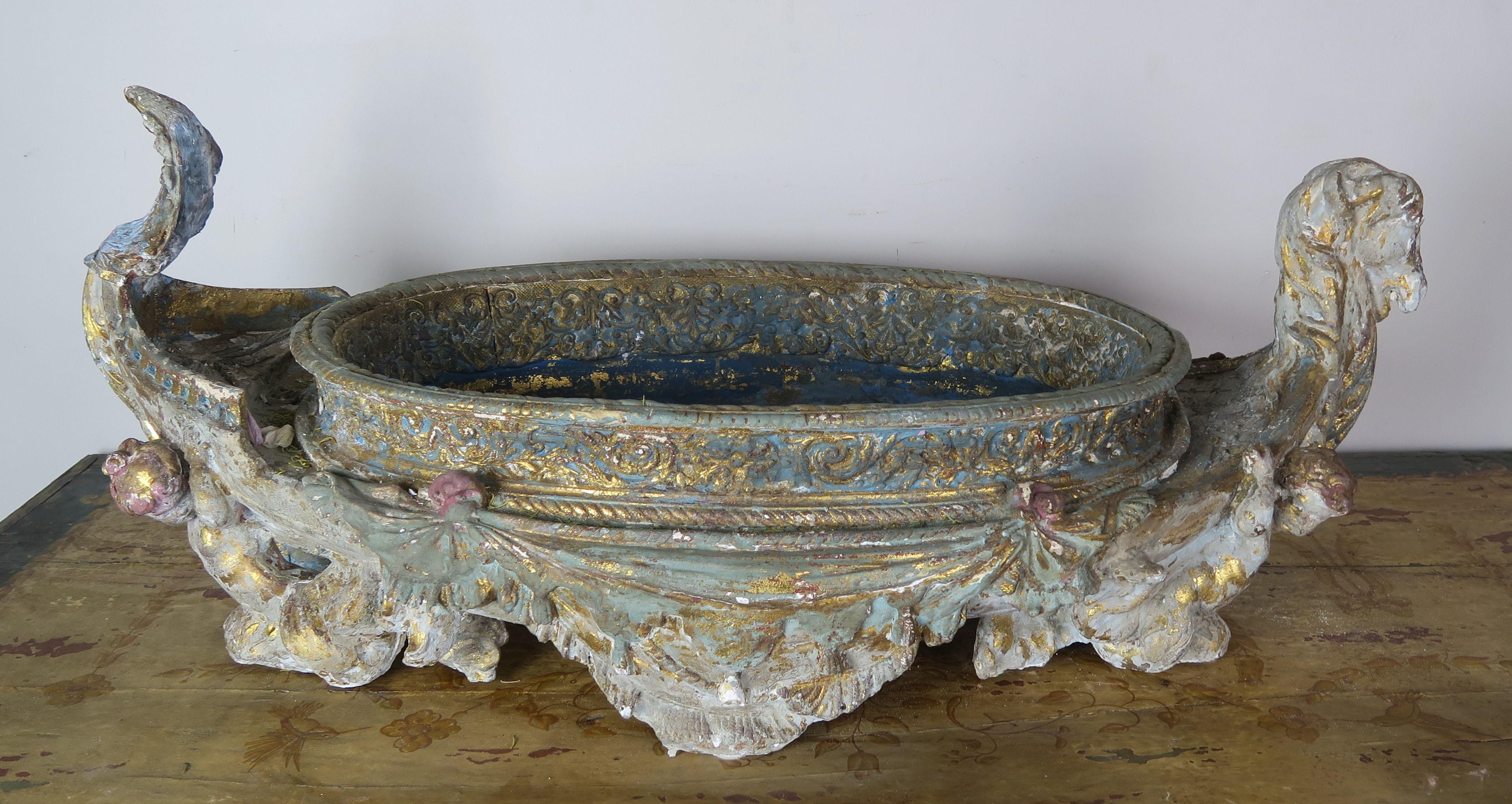 Large Venetian painted gondola shaped jardiniere with gold leaf highlights throughout. This vessel is painted in soft shades of blue, green, gray, pink and antique white mixed with accents of gold leaf. This piece is absolutely beautiful filled with