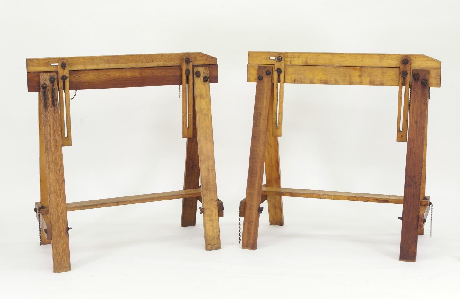 Pair of vintage adjustable saw horses, each fastened together with iron wing-nuts and bolts.
The white stenciling reads on the left horse in the lead photo reads, 