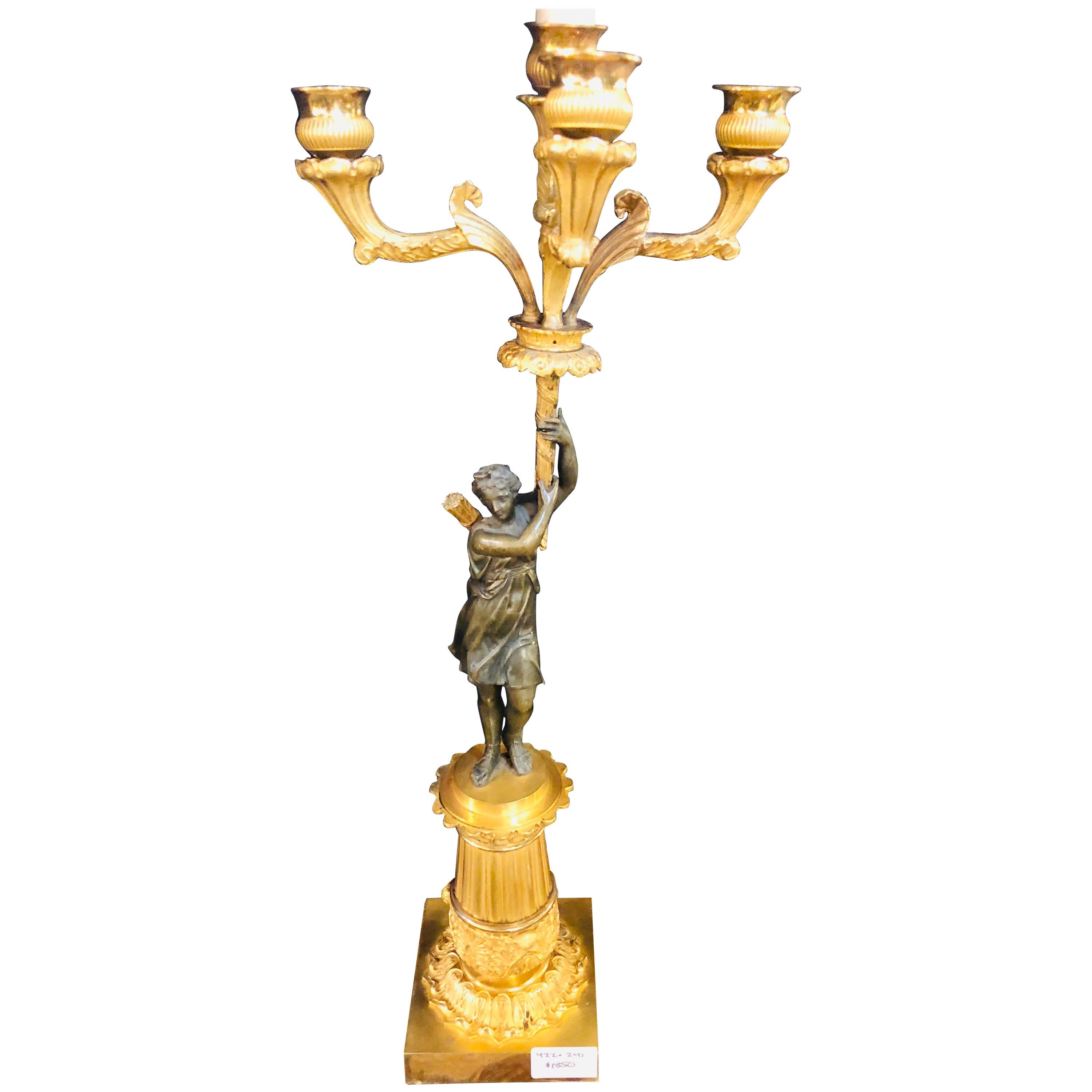 An Empire doré bronze candelabra lamp having a patinated woman mounted as a lamp. Part of our recent acquisition of fifty year collection from a Secaucus NJ antique shop comes this finely cast bronze candelabra lamp with stunning detailed shade.