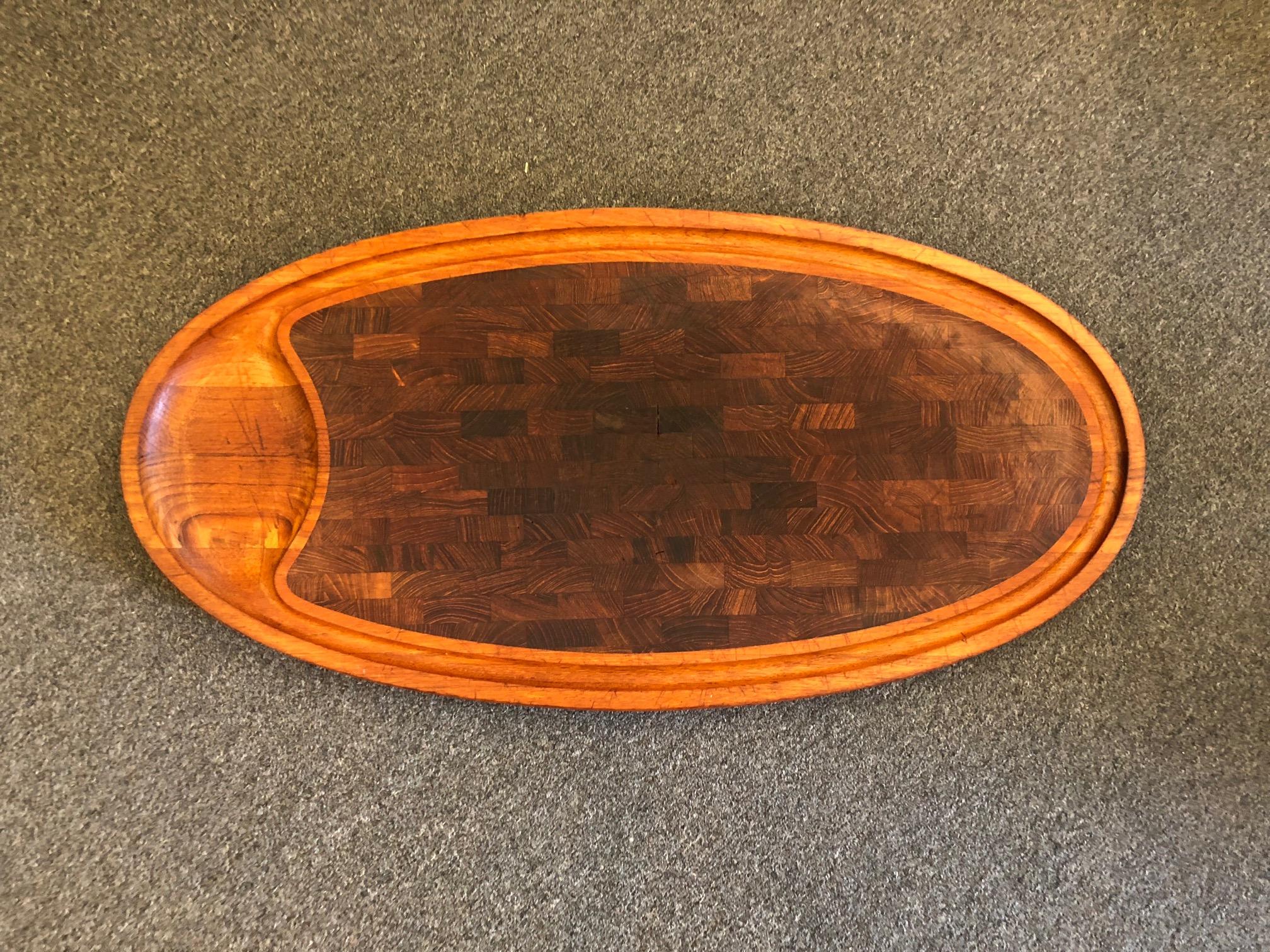 Massive solid teak butcher block cutting board designed by Jens Quistgaard for Dansk, circa 1950s. The piece is 30