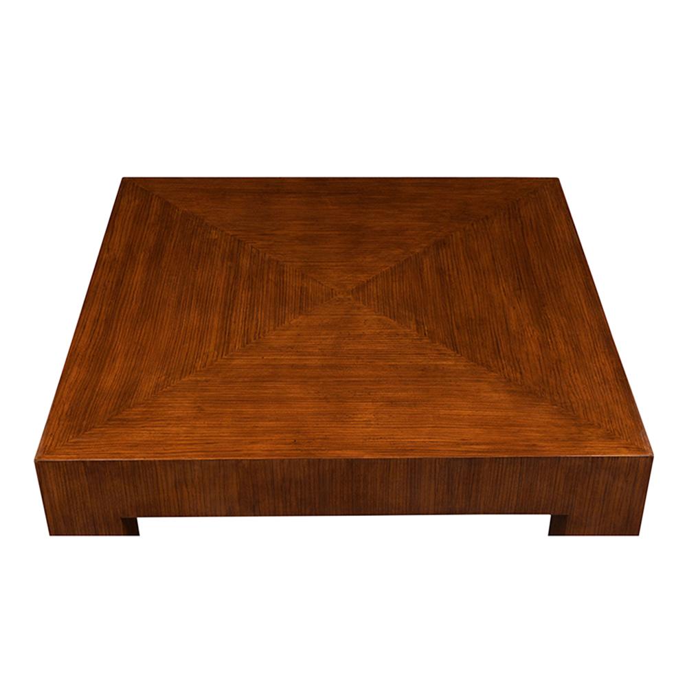 This Mid-Century Modern style coffee table, covered in an exotic Brazilian veneer, it is stained in a lovely light walnut color lacquered finish. The table's square legs all have chrome plated leg cap details. This coffee table is sturdy, sleek, and