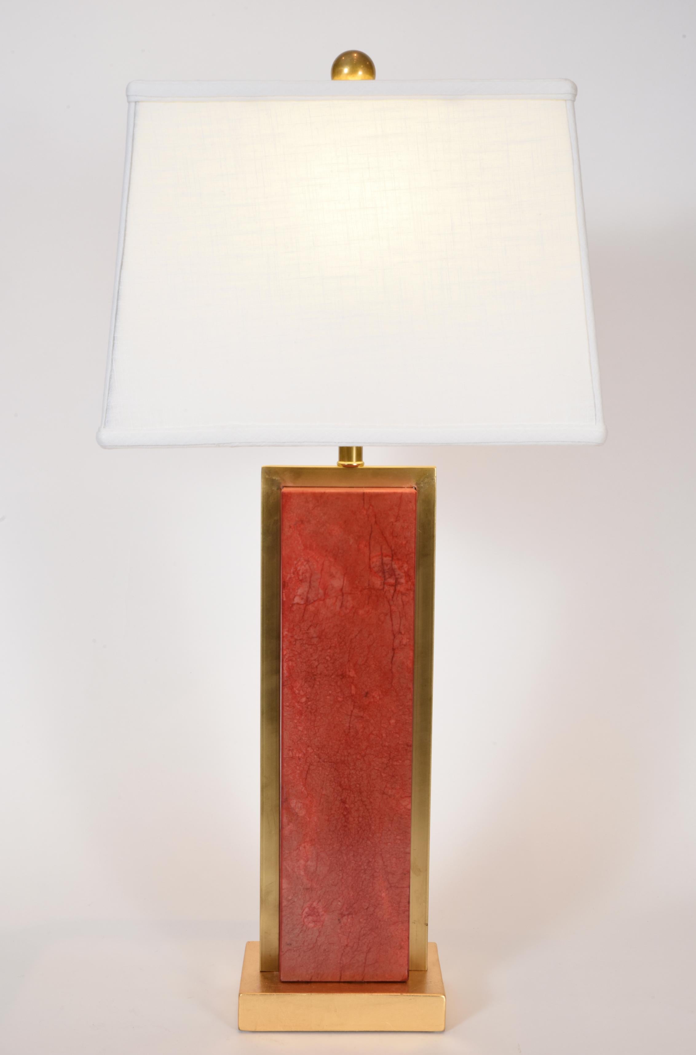 Pair of orange jade task / table lamps with brass frame accent design details with gold wooden base. Each lamp is in excellent working condition. Rewired for US use. Each lamp comes with a rectangle linen exterior / silk interior shade. Each shade
