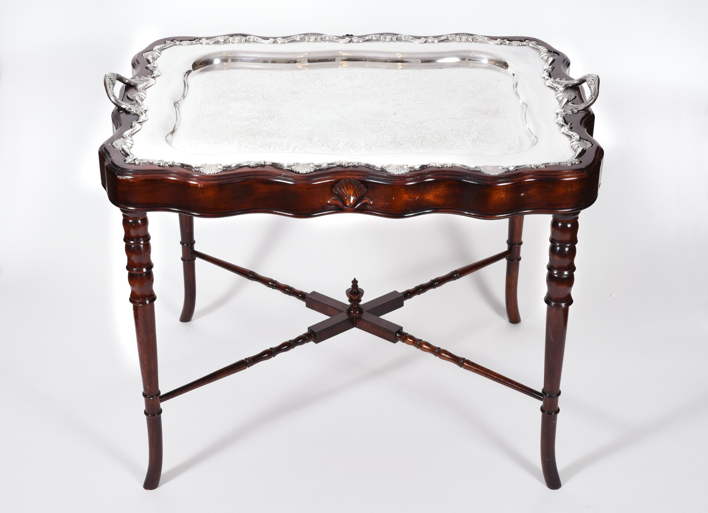 Vintage mahogany wood base frame completely removable silver plate tray table. The tray table is in excellent vintage condition. The table measure about 28 inches length X 21 inches width X 22 inches high.