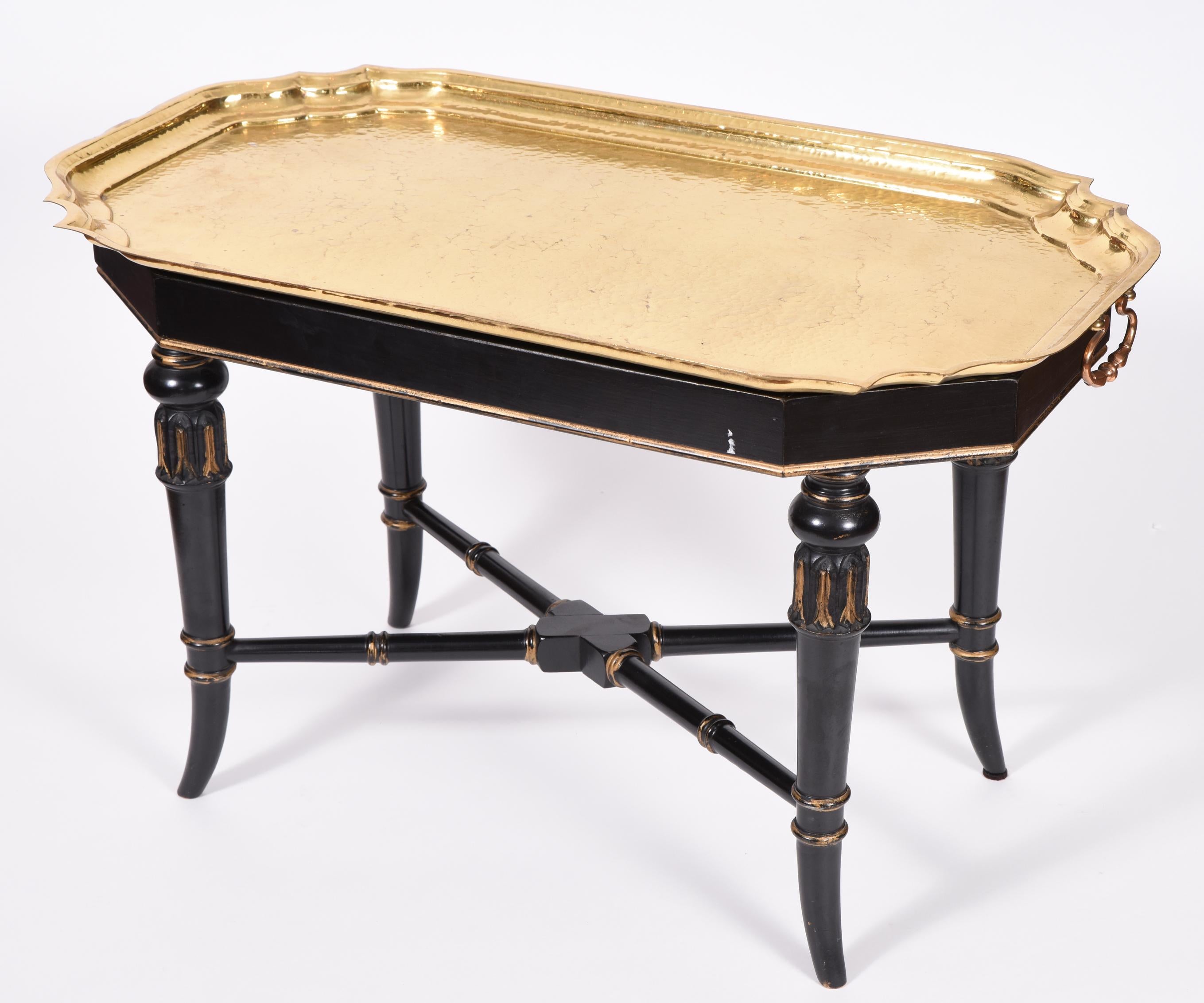 Early 20th century wood frame removable brass tray table with side handles. The table is in excellent vintage condition. The tray table measure about 31 inches length X 17 inches width X 18.5 inches high.