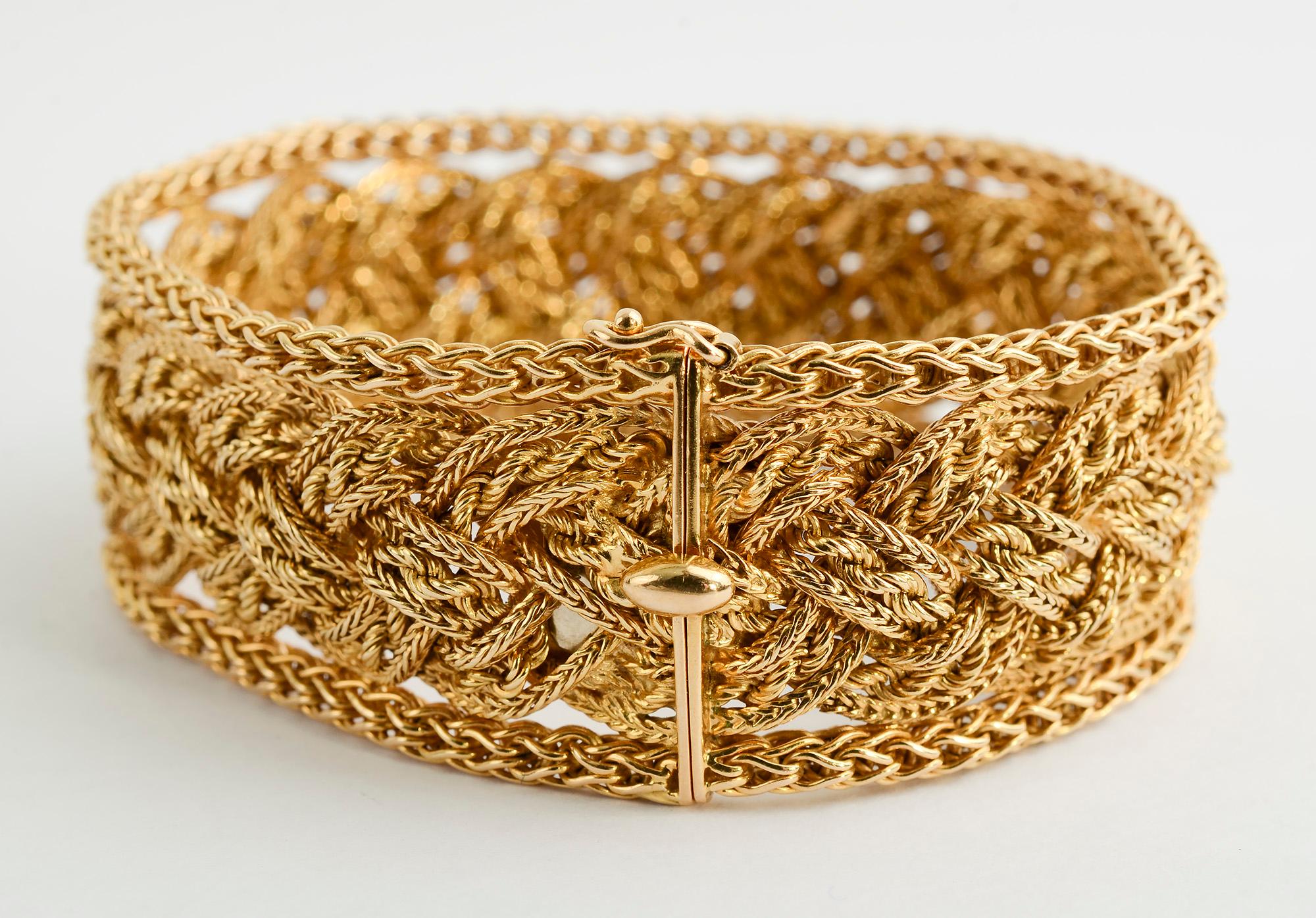 Elegant and finely detailed gold mesh bracelet by Bulgari. The interior is made of three strands of interwoven gold. The strands alternate between a herringbone pattern and a rope twist making for a very complex design. The bracelet is 7 1/8 inches