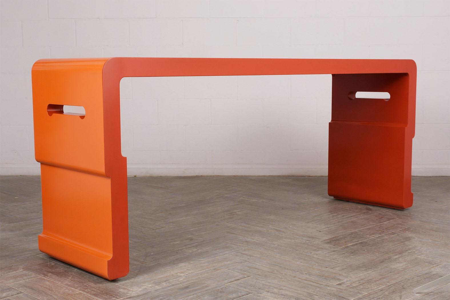 This modern-ish long 1970s console table is stained in an orange/red combination and has a beautiful lacquered finish. The console is solid and sturdy, ready to be used and enjoyed.