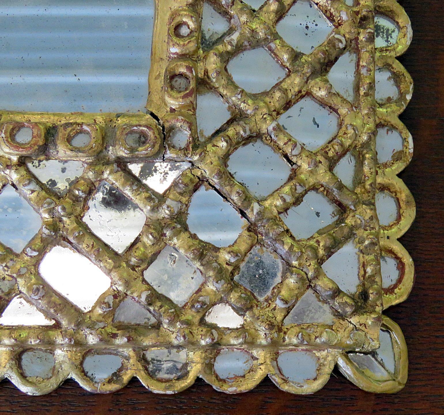 Antique accent table mirror with a distressed gilt frame.