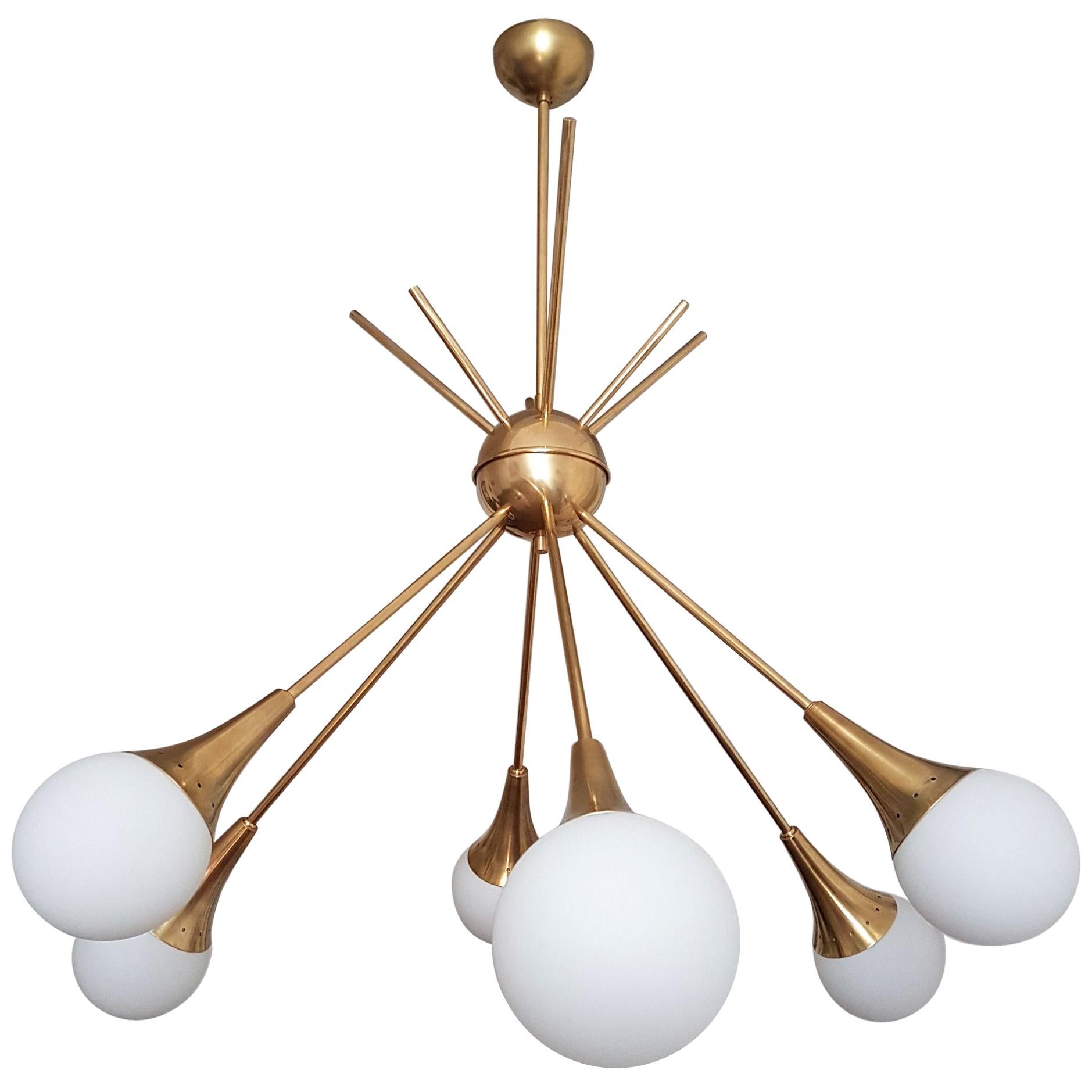 Two large Mid-Century Modern brass and white glass globes Sputnik chandeliers, in the style of Stilnovo.
Italy, early 1970s.
6 lights/globes each.
The pair has been rewired.
2 heights of stems alternate.
Sold and priced individually.