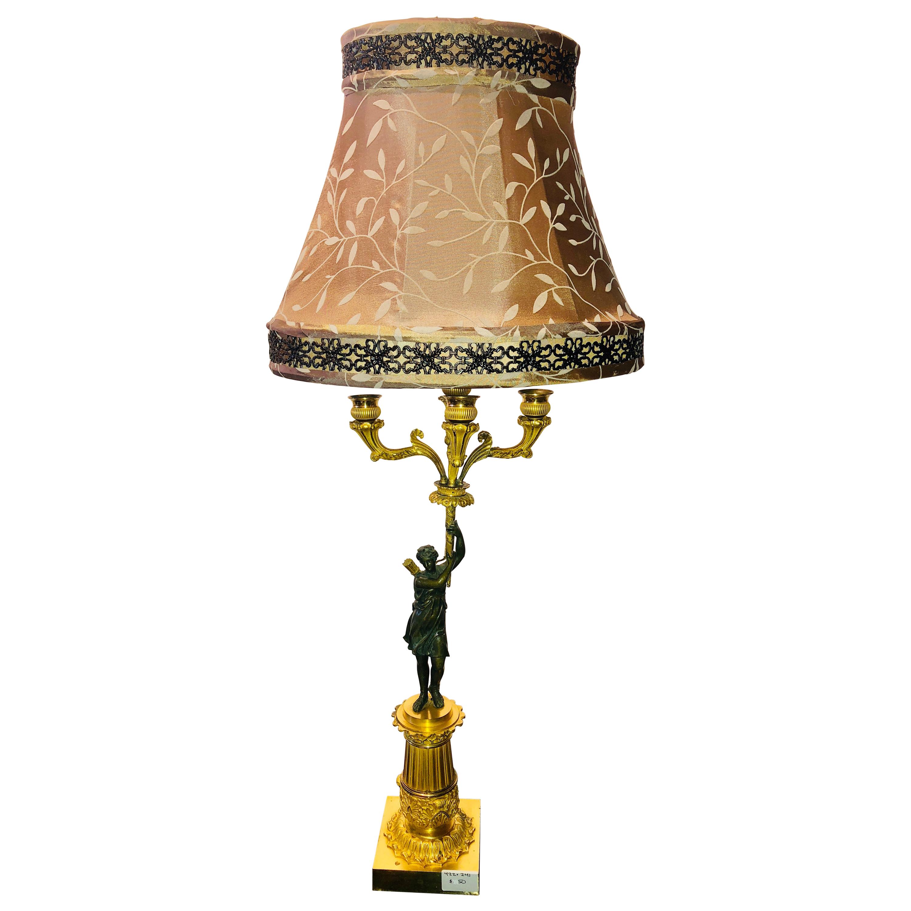 Empire Doré Bronze Candelabra Lamp Having a Patinated Woman Mounted as a Lamp