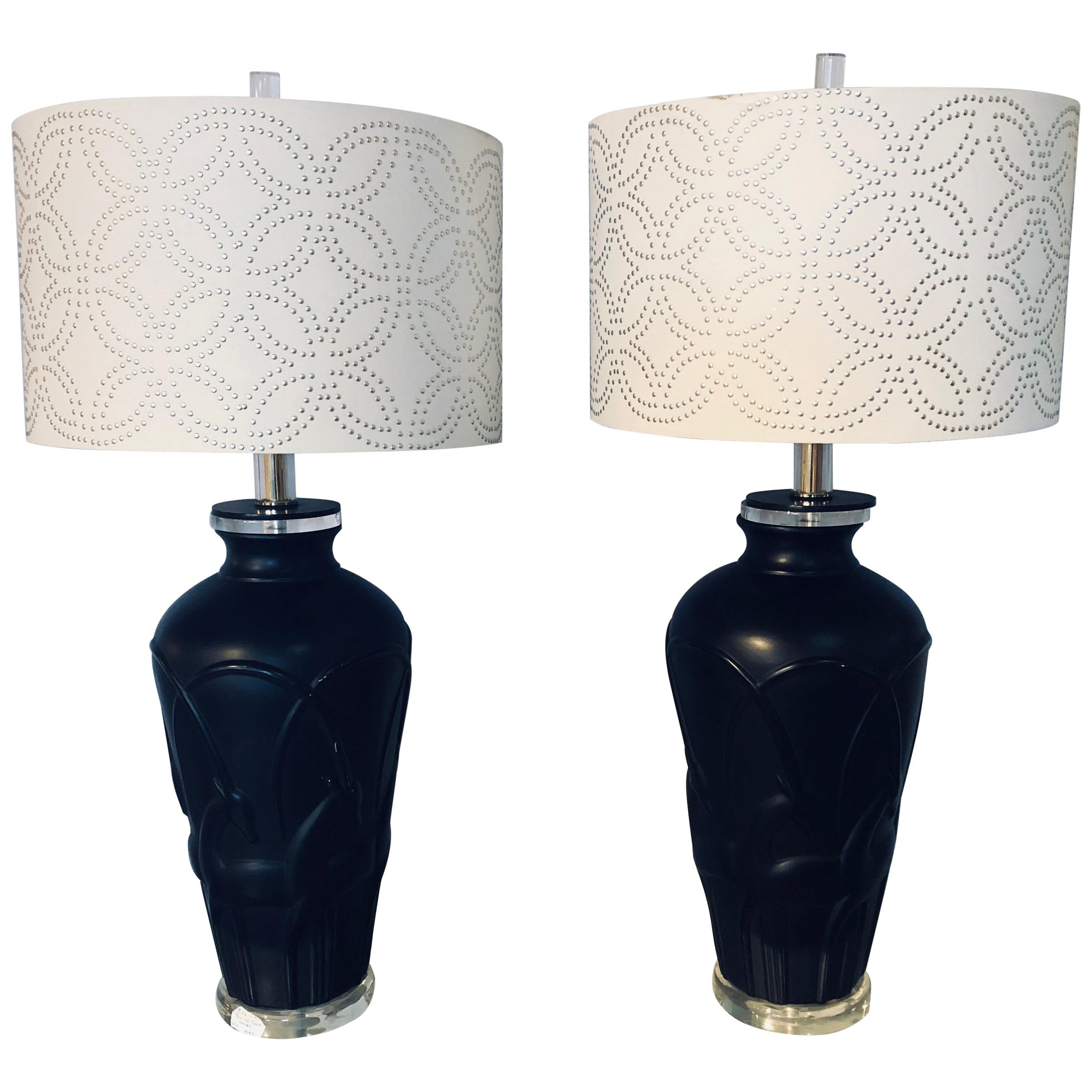 Pair of Art Deco style modern black table lamps Lucite base and Antelopes on the bodies. Each having a custom lamp shape with button form. Measures: Lampshades 10 inches high x 16 inches wide.