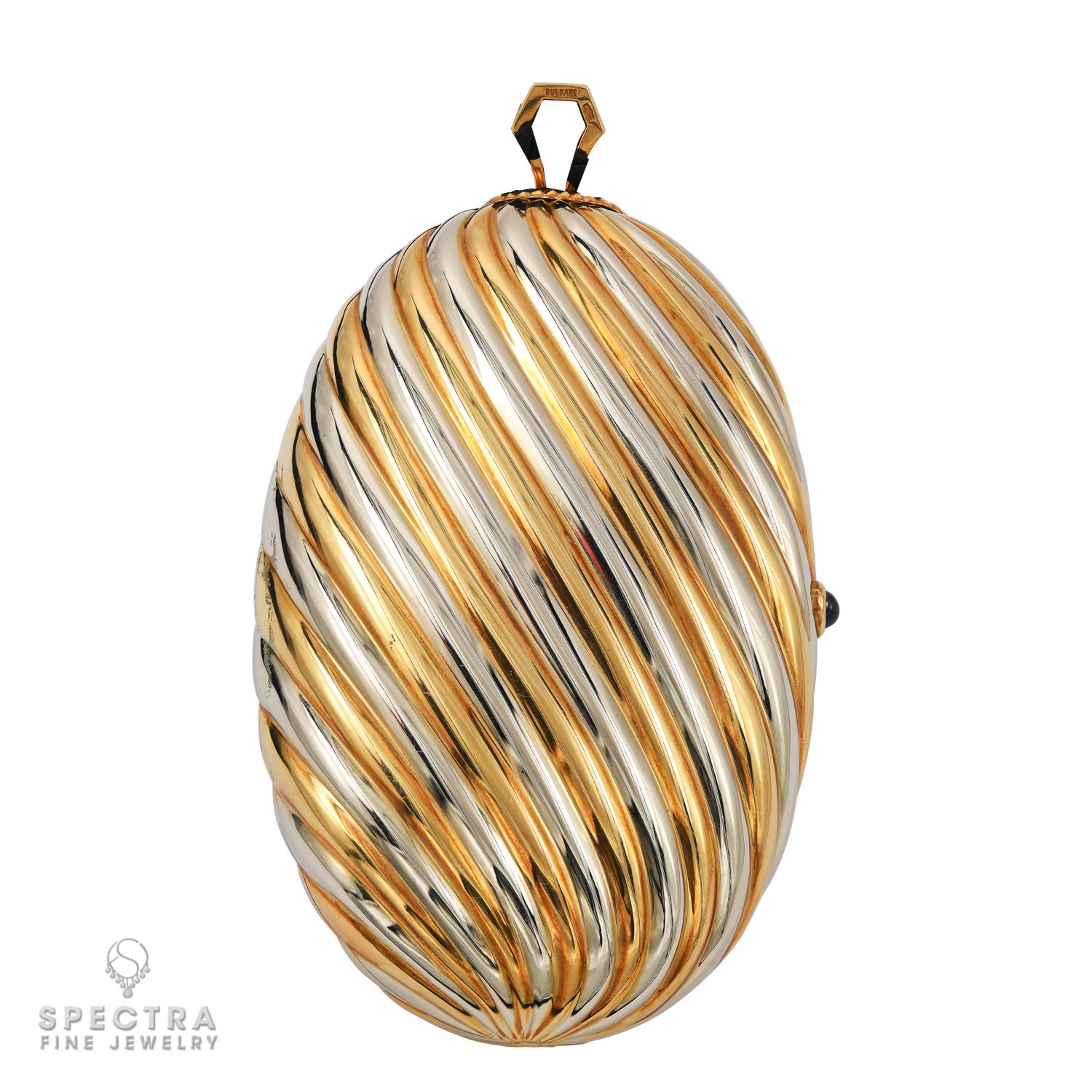 Una pochette da sera in oro giallo e bianco 18 carati, decorata con un bottone ovale di zaffiro cabochon, uno specchio all'interno della pochette. 
Firmato Bulgari. Ha una custodia Bulgari.
Circa 1970.
Dimensioni: 
13.7 x 8.9 x 3.2 cm (5 3⁄8 x 3 1⁄2