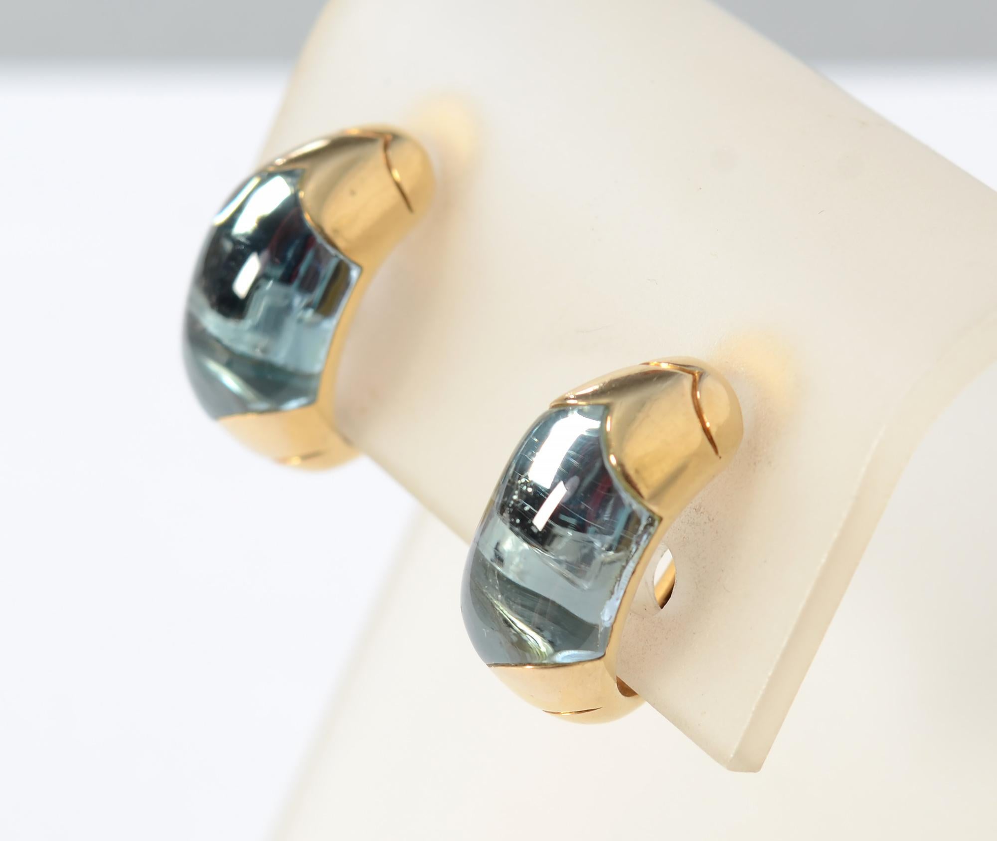 These are the perfect daytime half hoop earrings by Bulgari. They are centered with blue topaz in a stunning shade of watery blue. In real life, the color is more like that of the thumbnails than the overall image. Clip backs can be converted to