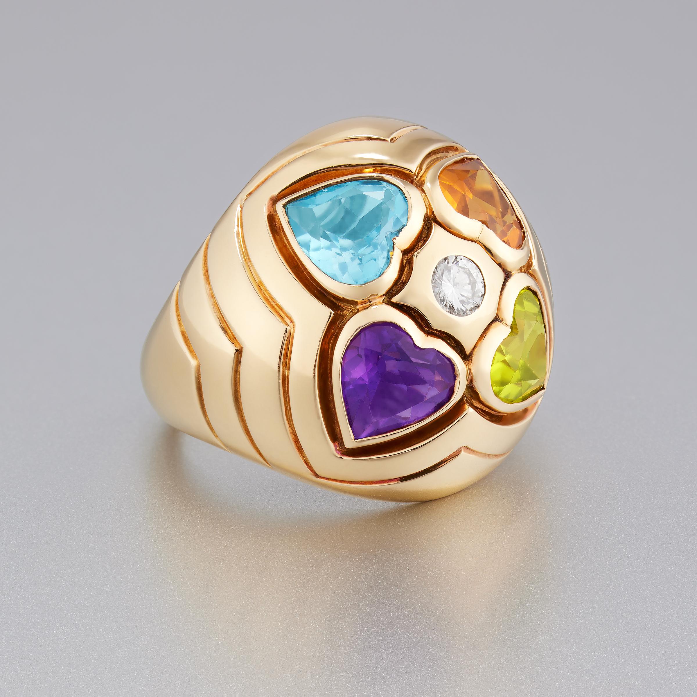 From the iconic Bulgari comes this joyous multi-colored gemstone and diamond dome ring set in 18 karat yellow gold. The ring is a perfect expression of love as its four vivid gems - which include blue topaz, amethyst, peridot, and citrine - are all