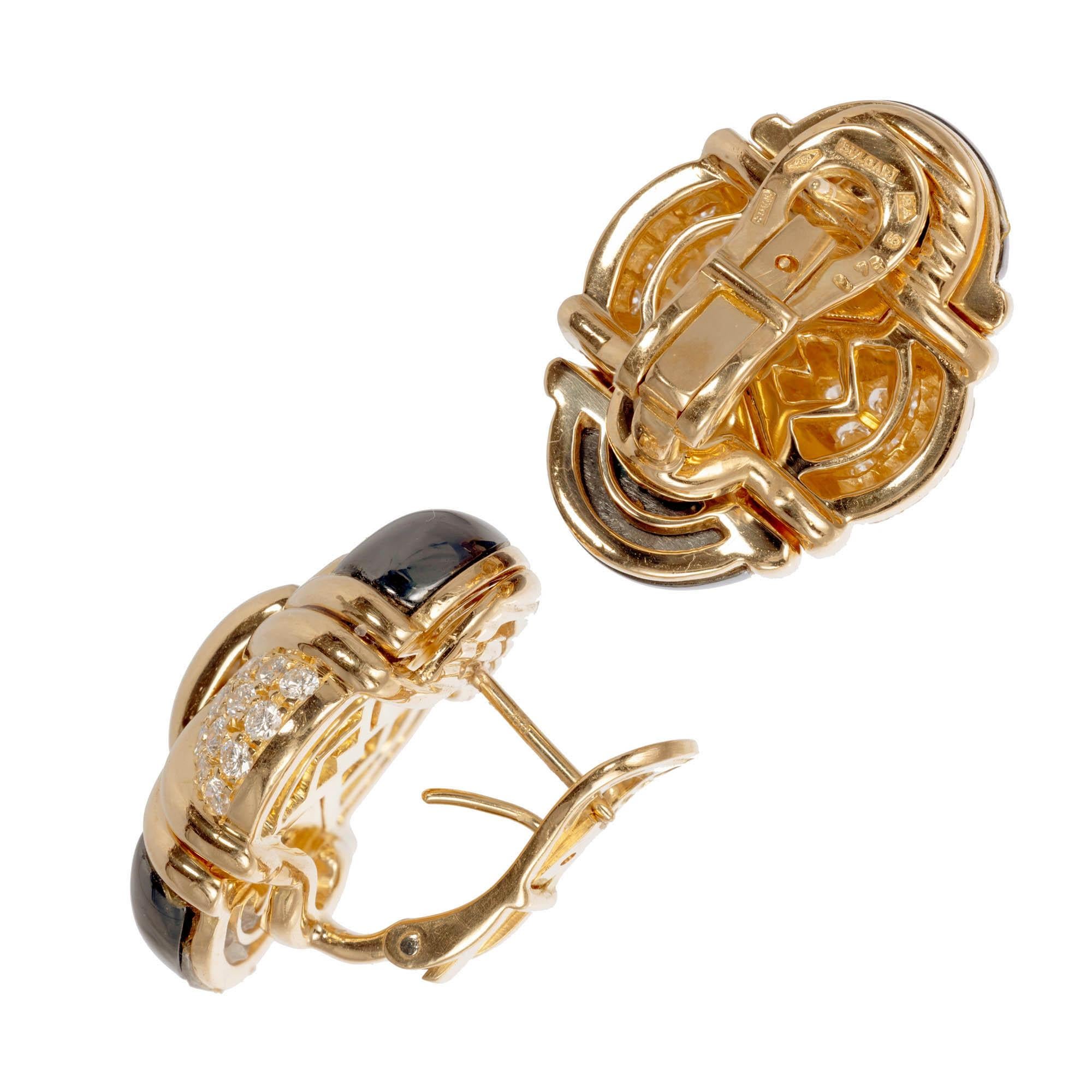 Bvlgari hematite and diamond solid 18k yellow gold clip post earrings.

56 round brilliant cut F-G WS diamonds Approximate 1.60 carats 
4 hematite
14k yellow gold 
Stamped: 750
Hallmark: Bvlgari
43.9 Grams
Top to Bottom: 25.86mm or 1.00