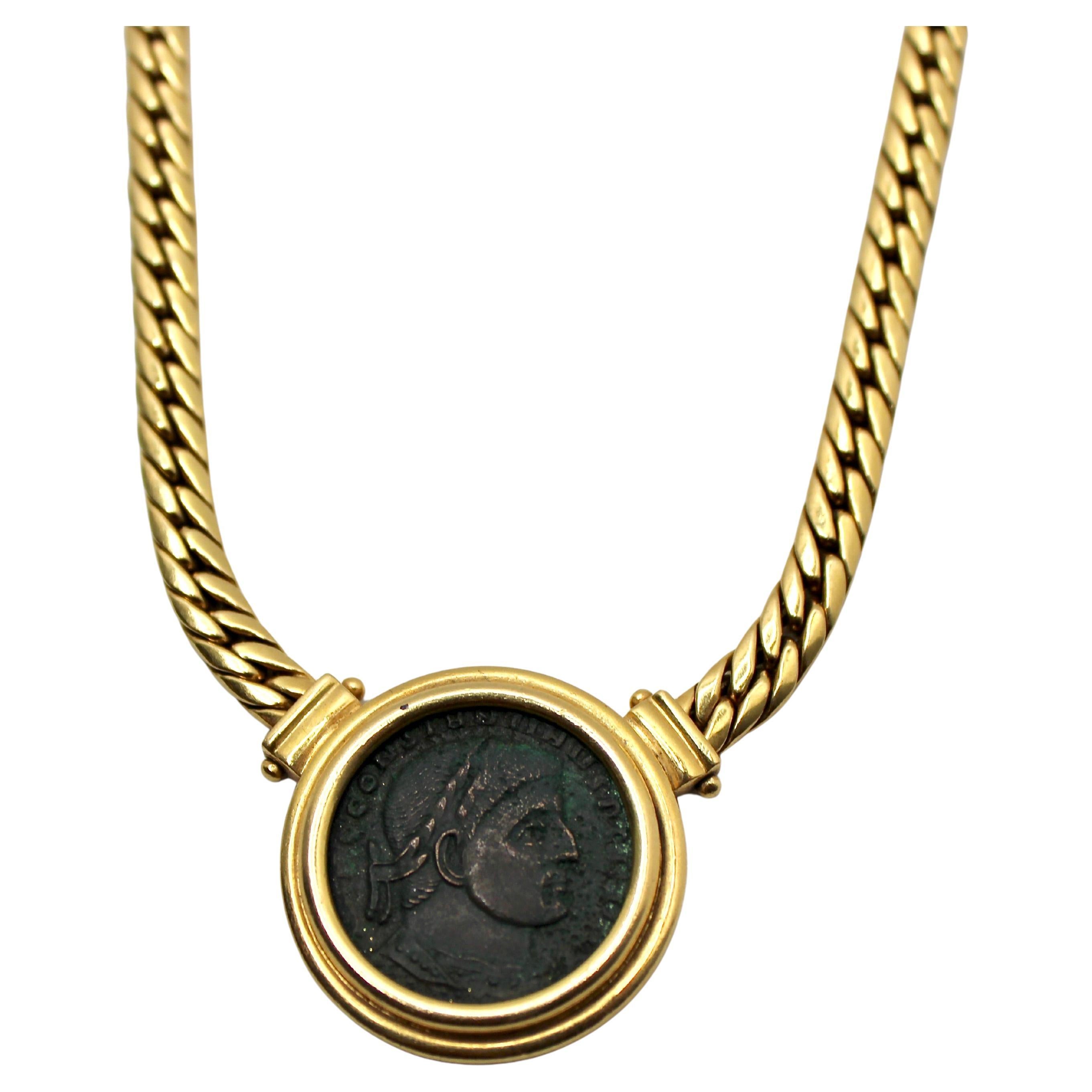 This Bulgari-inspired Monete 18k Yellow Gold Roman Coin Pendant Necklace circa 1970s is a remarkable piece of jewelry that blends ancient history with timeless elegance. The focal point of this necklace is a bronze Roman coin featuring the motif of